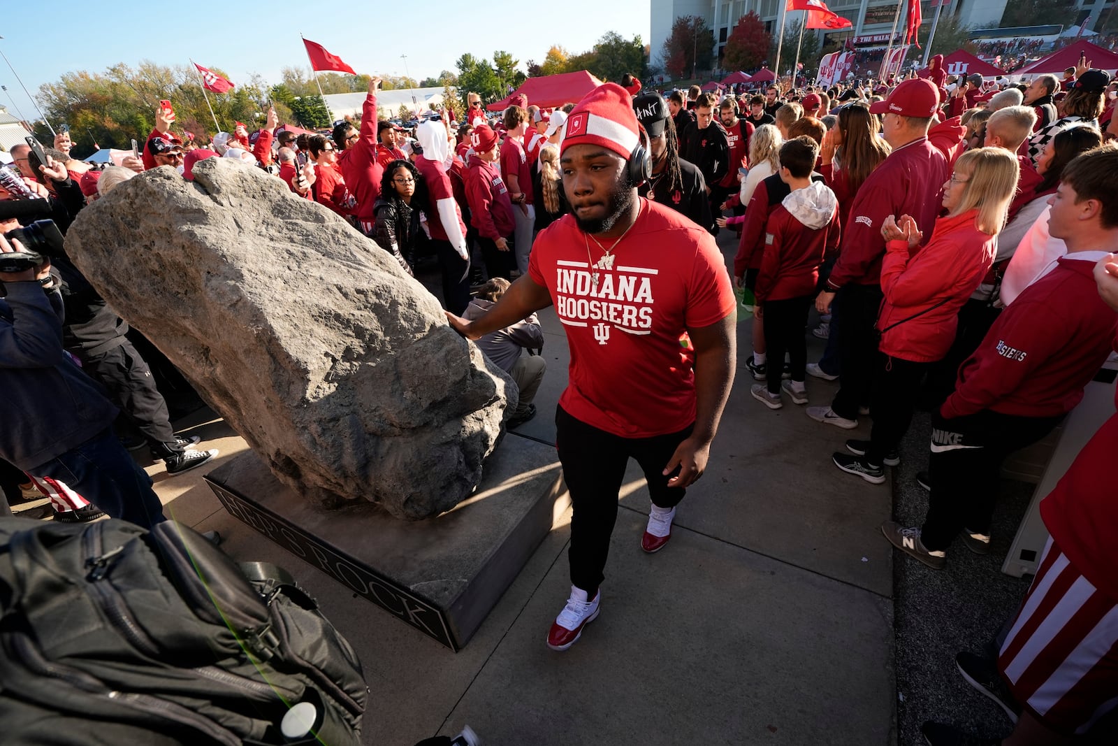 Indiana football players touch "Hep's Rock" and they enter Memorial Stadium before an NCAA college football game against the Washington, Saturday, Oct. 26, 2024, in Bloomington, Ind. (AP Photo/Darron Cummings)