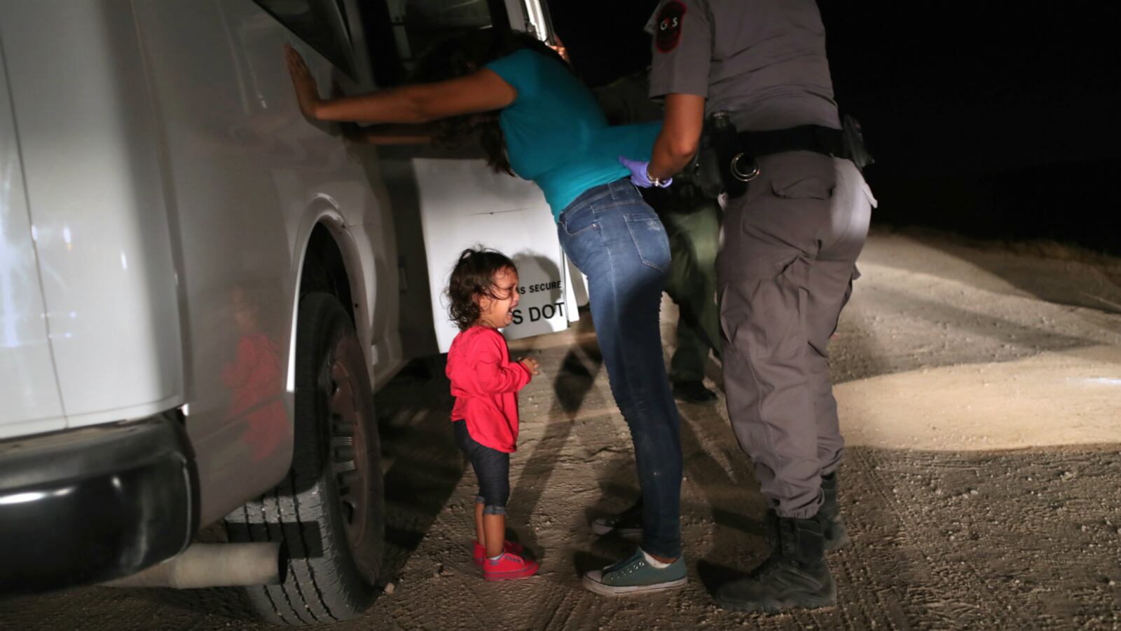 A two-year-old Honduran asylum seeker cries as her mother is searched and detained near the U.S.-Mexico border on June 12, 2018 in McAllen, Texas. The asylum seekers had rafted across the Rio Grande from Mexico and were detained by U.S. Border Patrol agents before being sent to a processing center for possible separation.