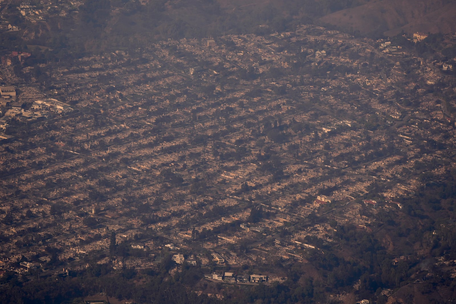 The devastation from the Palisades Fire is seen from the air in the Pacific Palisades neighborhood of Los Angeles, Thursday, Jan. 9, 2025. (AP Photo/Mark J. Terrill)