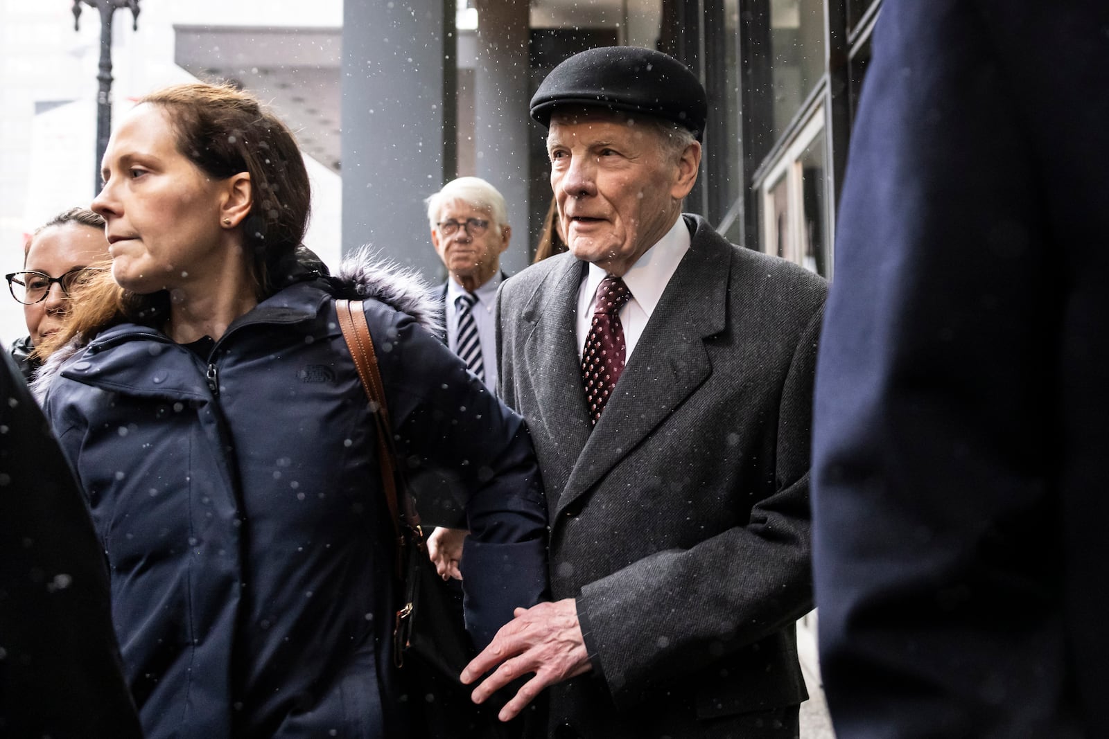 Flanked by supporters and holding hands with his daughter Nicole, Illinois' former House Speaker Michael Madigan walks out of the Dirksen Federal Courthouse in Chicago, Wednesday, Feb. 12, 2025. (Ashlee Rezin/Chicago Sun-Times via AP)