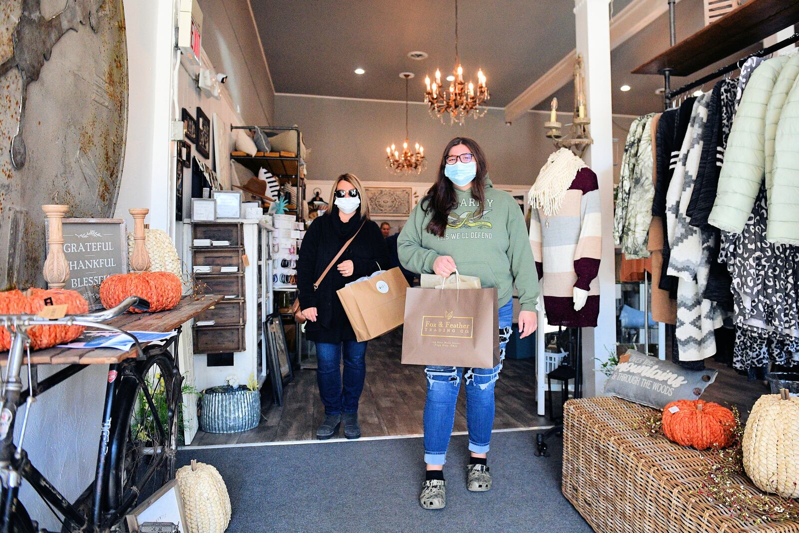 Shoppers leave Fox and Feather in downtown Tipp City during the annual Yuletide Winter's Gathering activities. Business supporters throughout the region are encouraging shopping local to assist businesses that have had a tough year thanks to COVID-19.