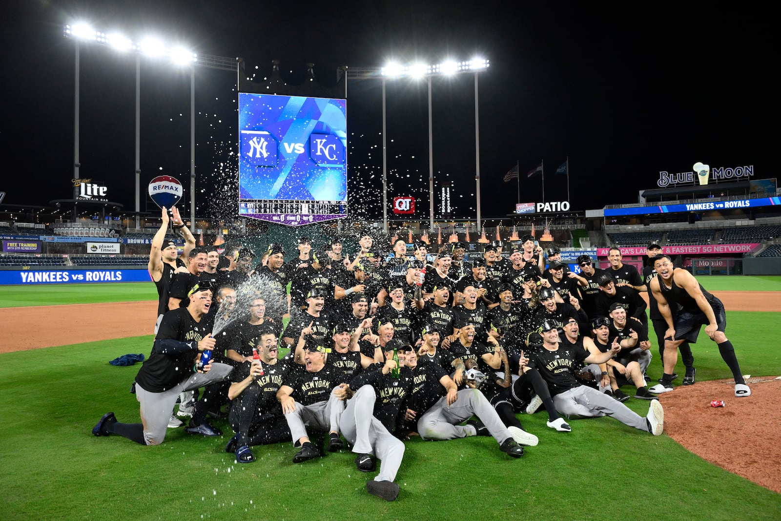 Members of the New York Yankees celebrate following a 3-1 victory over the Kansas City Royals in Game 4 of an American League Division baseball playoff series Thursday, Oct. 10, 2024, in Kansas City, Mo. (AP Photo/Reed Hoffmann)