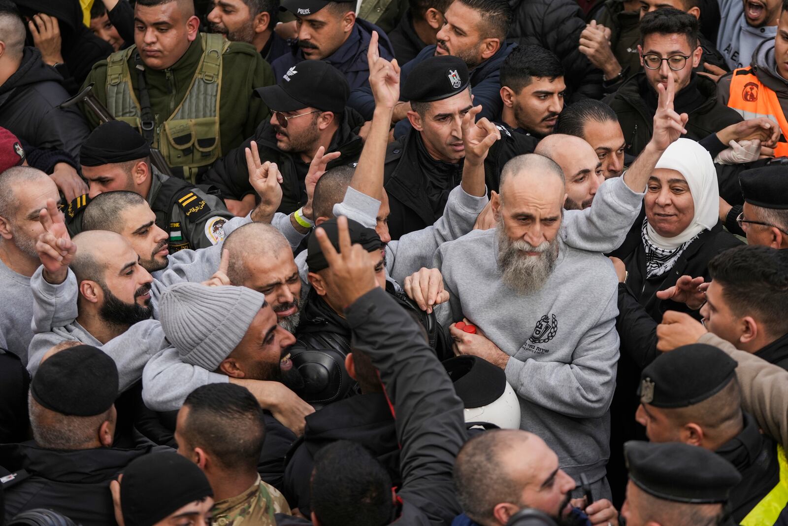 Palestinian Raed Al-Saadi, 57, right, and another prisoners are greeted by a crowd after being released from Israeli prison following a ceasefire agreement with Israel, in the West Bank city of Ramallah, Saturday, Jan. 25, 2025. (AP Photo/Mahmoud Illean)