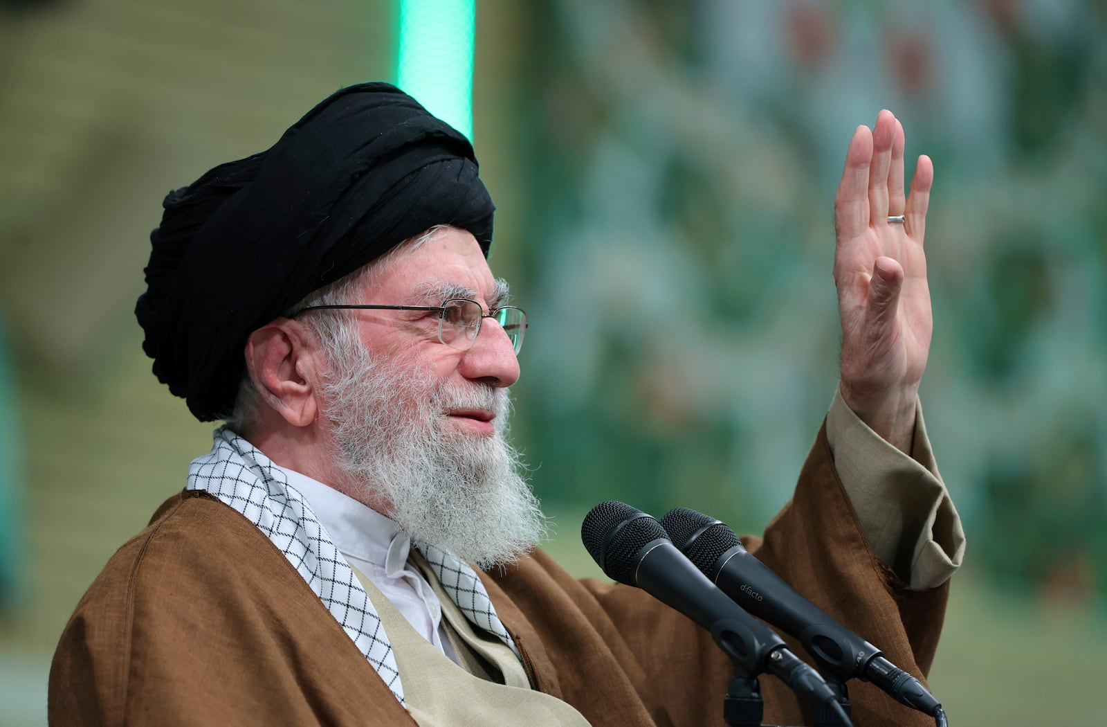 In this photo released by an official website of the office of the Iranian supreme leader, Supreme Leader Ayatollah Ali Khamenei waves to the crowd during a meeting in Tehran, Iran, Sunday, Dec. 22, 2024. (Office of the Iranian Supreme Leader via AP)