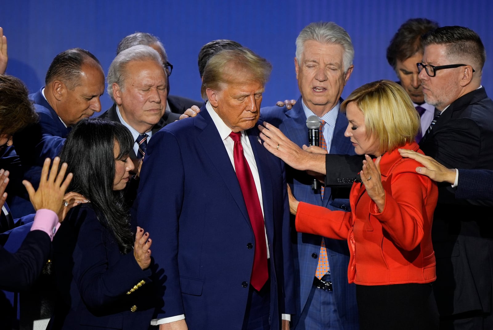 Republican presidential nominee former President Donald Trump is prayed over with Pastor Paula White during the National Faith Summit at Worship With Wonders Church, Monday, Oct. 28, 2024, in Powder Springs, Ga. (AP Photo/Brynn Anderson)