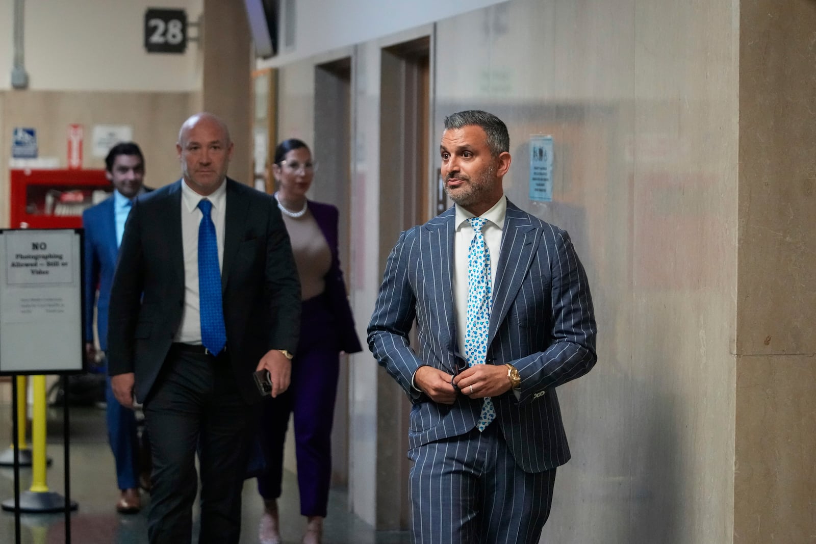 Defense attorney Saam Zangeneh, right, walks out of the courtroom at the Hall of Justice for the murder trial of Nima Momeni, Tuesday, Dec. 3, 2024, in San Francisco. (AP Photo/Godofredo A. Vásquez)