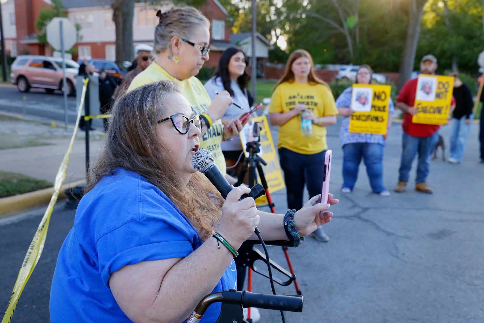 Dani Allen, an anti-death penalty advocate, speaks during a protest outside the prison where Robert Roberson is scheduled for execution at the Huntsville Unit of the Texas State Penitentiary, Thursday, Oct. 17, 2024, in Huntsville, Texas. (AP Photo/Michael Wyke)