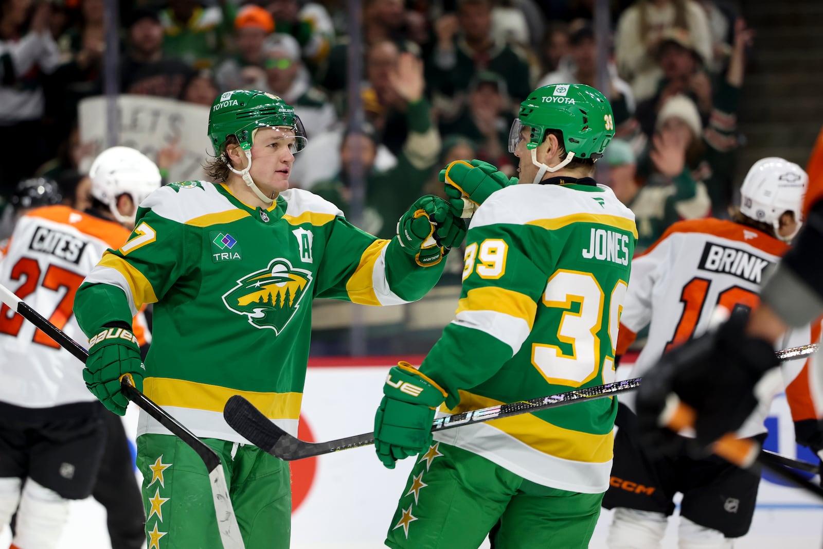 Minnesota Wild left wing Kirill Kaprizov, left, celebrates his goal with center Ben Jones (39) during the first period of an NHL hockey game against the Philadelphia Flyers, Saturday, Dec. 14, 2024, in St. Paul, Minn. (AP Photo/Ellen Schmidt)