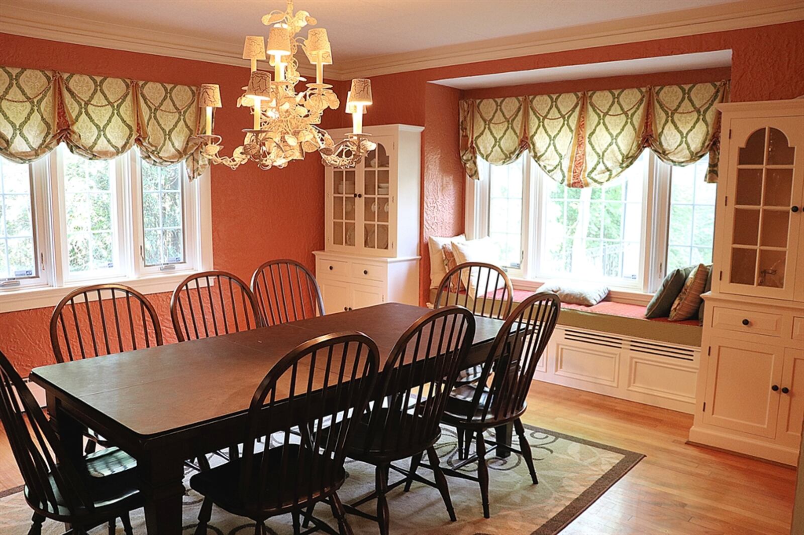 The formal dining room has built-in hutches that flank a window seat. 