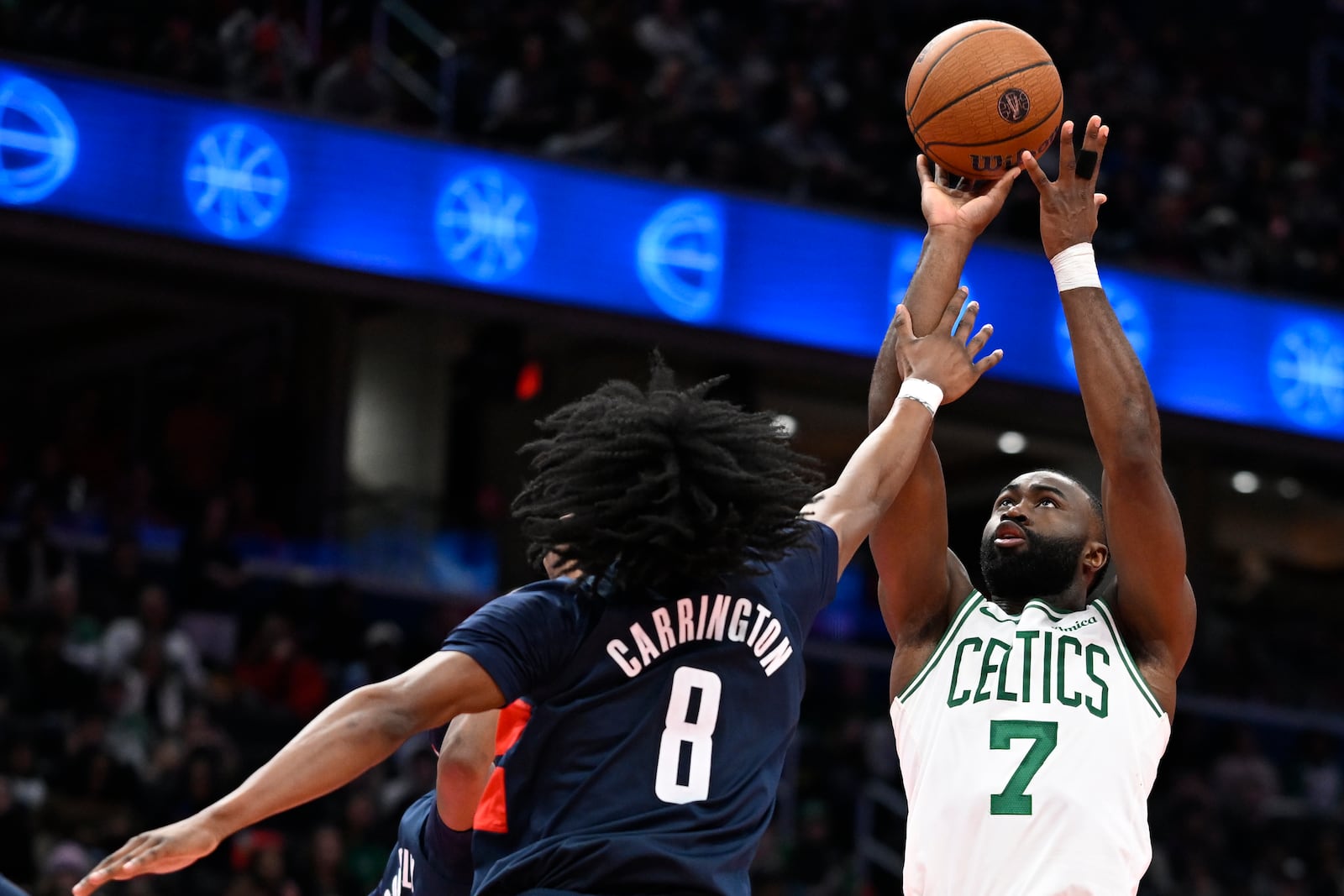 Boston Celtics guard Jaylen Brown (7) scores a basket over Washington Wizards guard Carlton Carrington (8) during the second half of an Emirates NBA Cup basketball game tonight Friday, Nov. 22, 2024, in Washington. (AP Photo/John McDonnell)