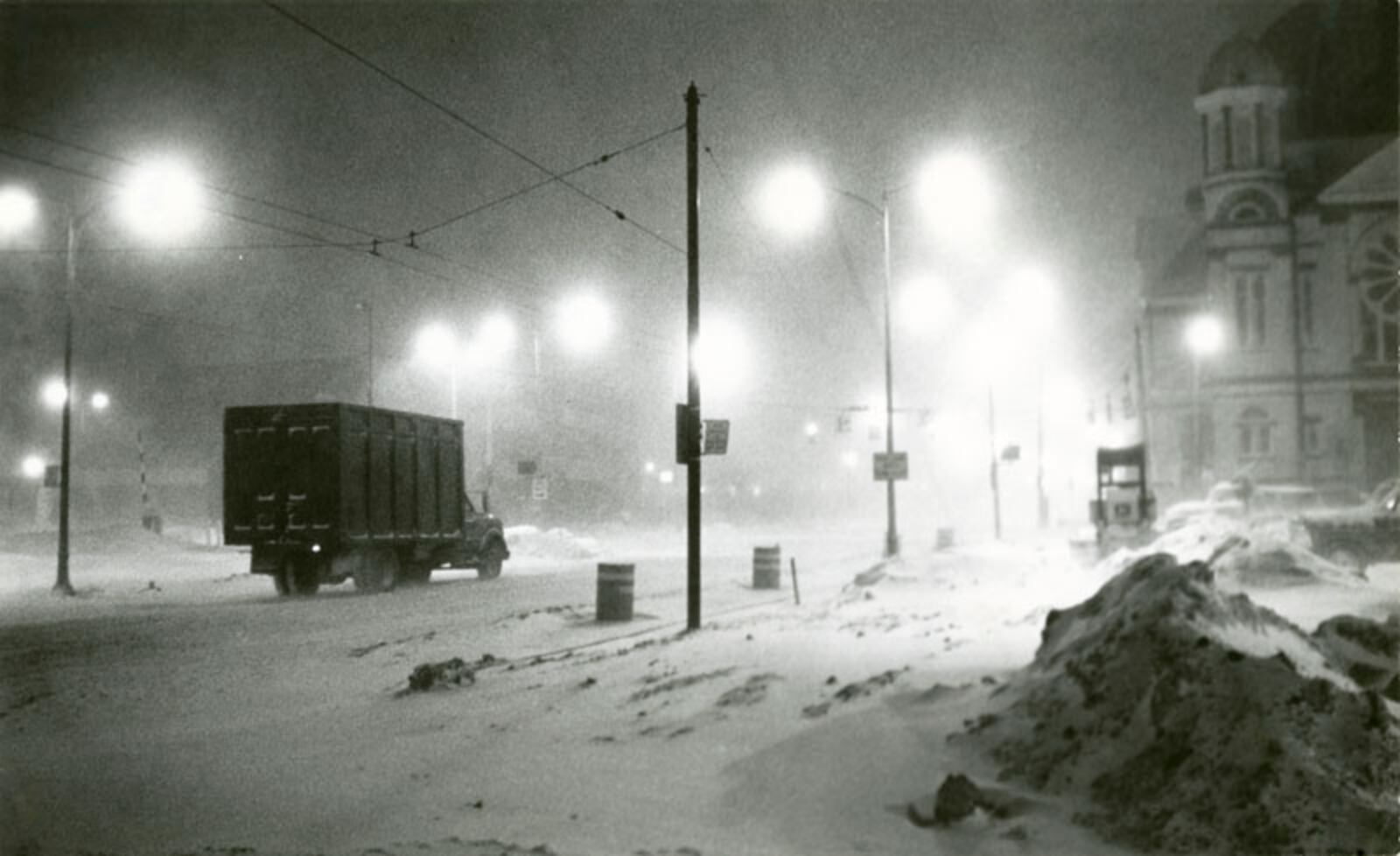 A delivery truck plows it way down Fourth Street in the early morning blizzard.