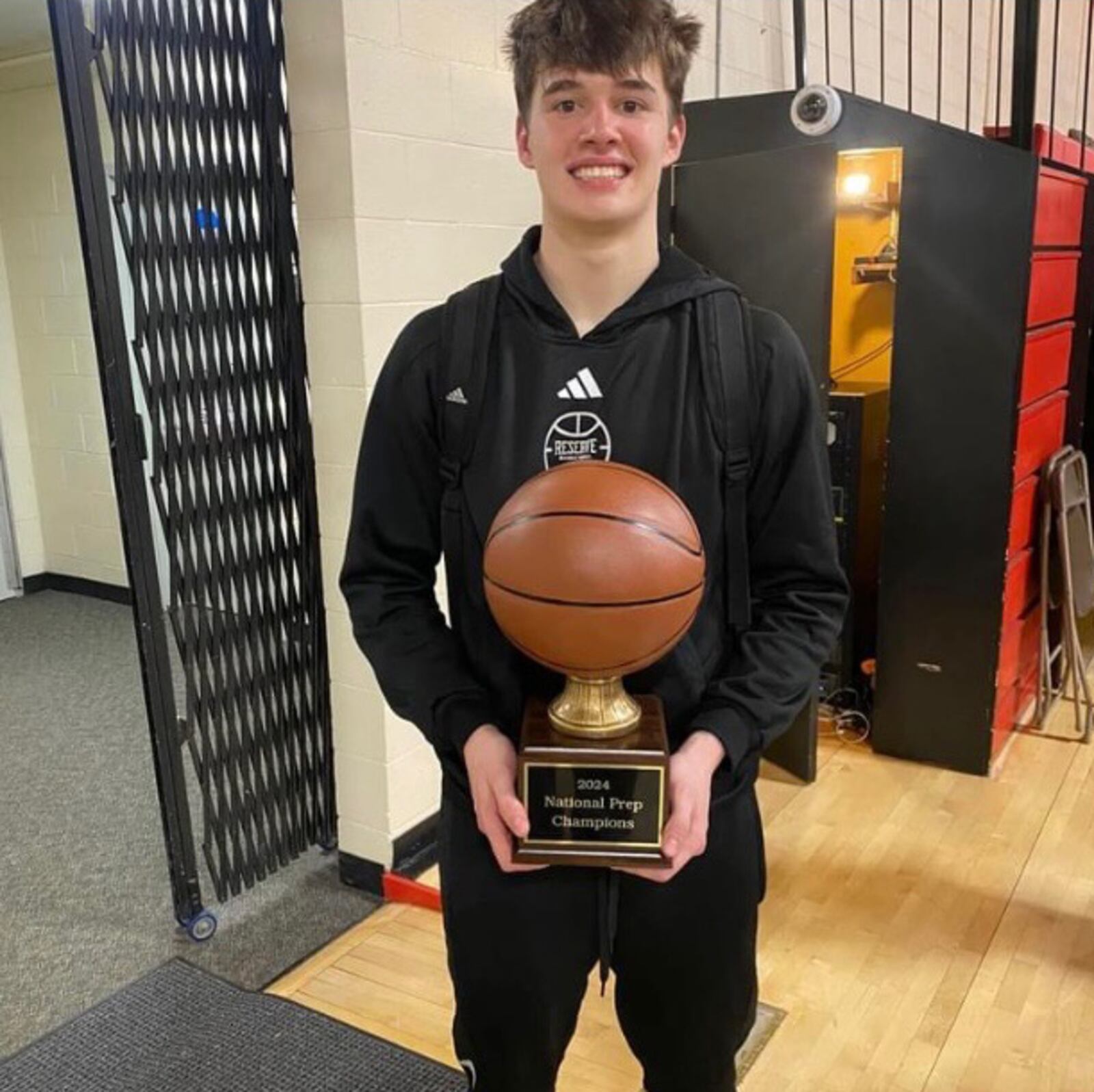 Former Centerville and Tecumseh player Collin O'Connor holds the prep school national championship trophy he won this season as point guard for Western Reserve Academy. CONTRIBUTED