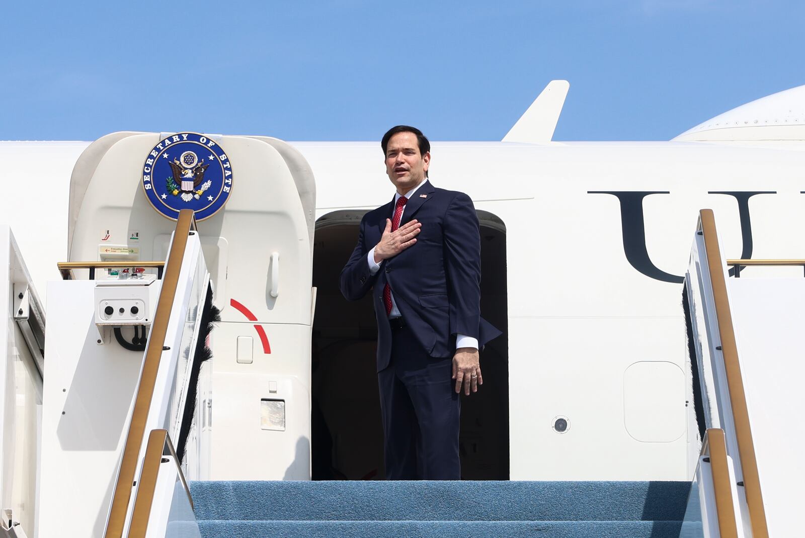 U.S. Secretary of State Marco Rubio boards an aircraft to depart to the U.S., in Abu Dhabi, United Arab Emirates, Wednesday, Feb. 19, 2025. (Evelyn Hockstein/Pool Photo via AP)