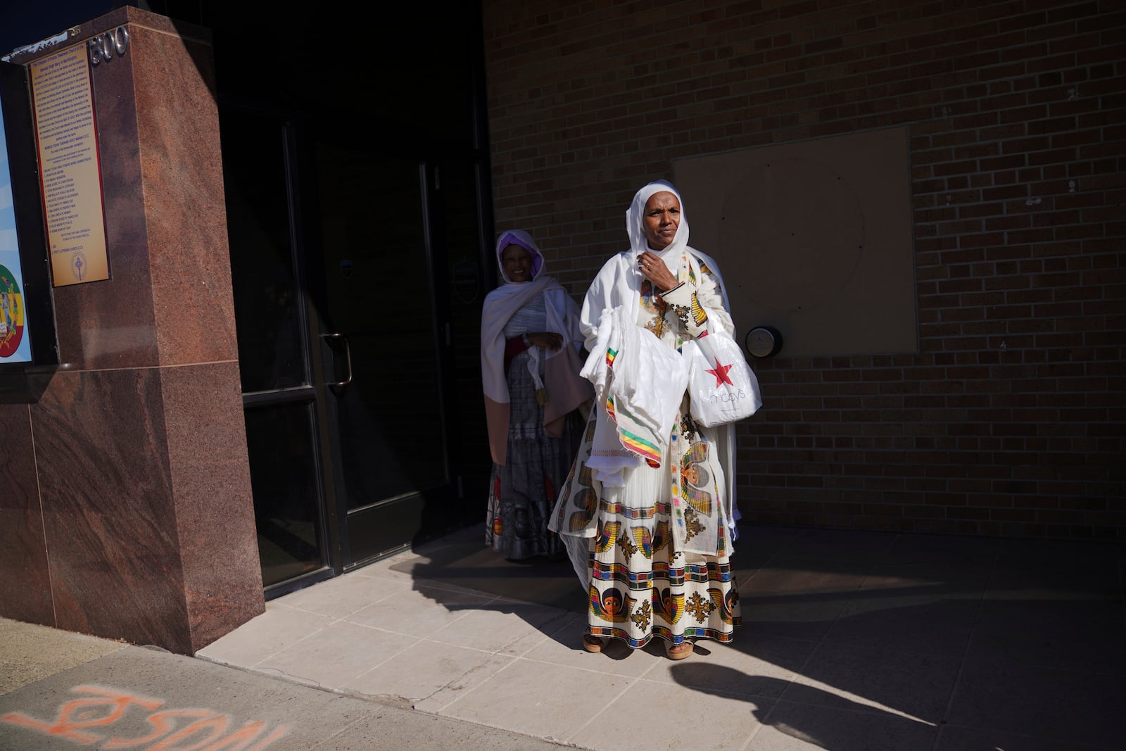 Women stand outside of the Ethiopian Orthodox Tewahedo Church after service on Sunday, Oct. 20, 2024, in Worthington, Minn. (AP Photo/Jessie Wardarski)