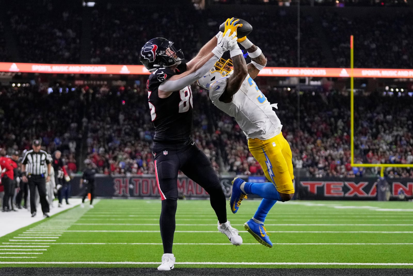 Los Angeles Chargers safety Derwin James Jr. (3) intercepts a pass intended for Houston Texans tight end Dalton Schultz in the end zone during the second half of an NFL wild-card playoff football game Saturday, Jan. 11, 2025, in Houston. (AP Photo/Eric Christian Smith)