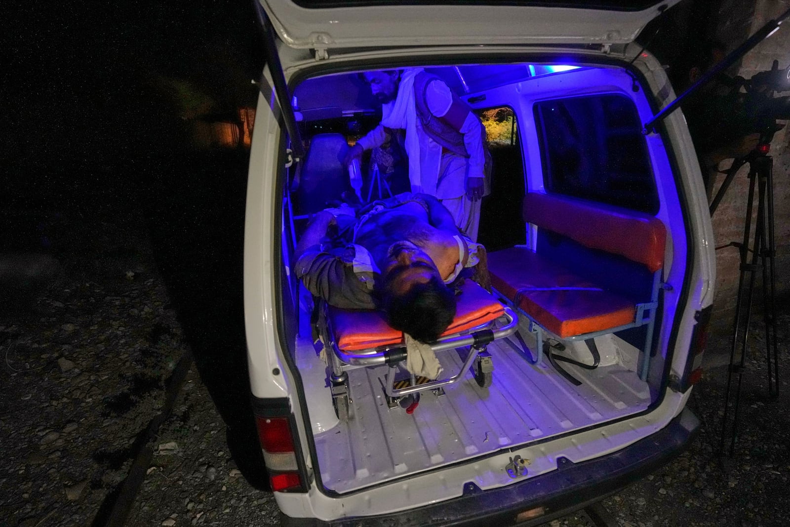 An injured passenger rescued by security forces from a passenger train attacked by insurgents is carried in an ambulance after arriving on a special train for injured and survivors organised by the army, at a railway station in Much, Pakistan's southwestern Balochistan province, Wednesday, March 12, 2025. (AP Photo/Anjum Naveed)