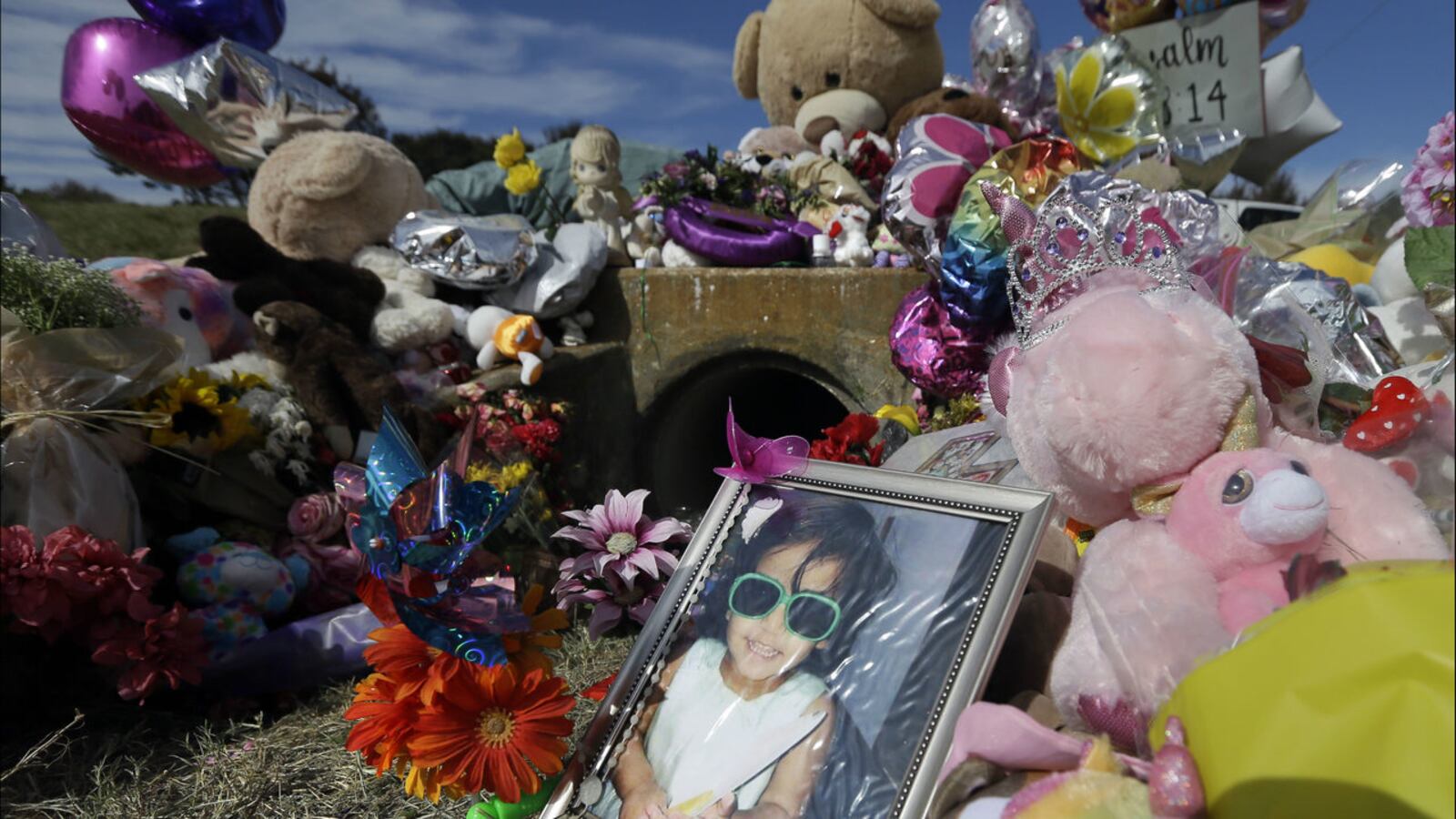 In this October 2017 photo, a photo of 3-year-old Sherin Mathews is shown at a makeshift memorial outside the culvert where her decomposed body was found in Richardson, Texas. The girl's father has been sentenced to life in prison in her death.