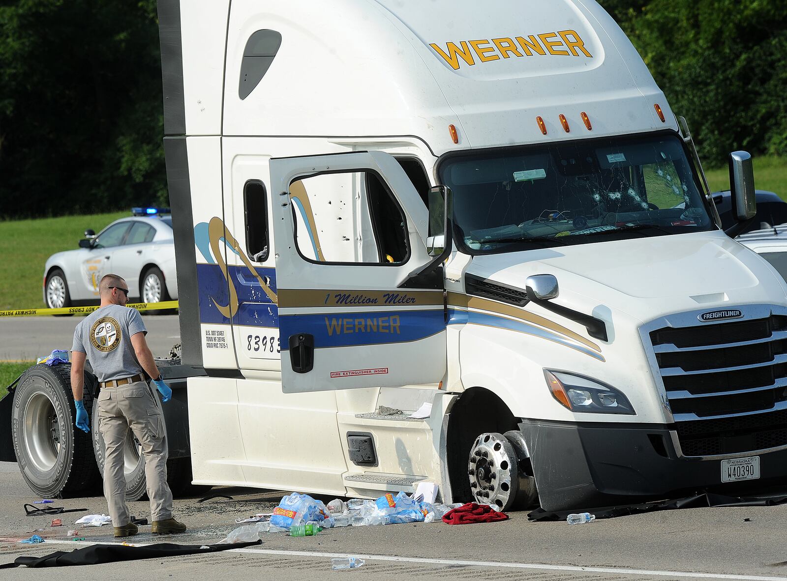 A member of BCI looks over a semi that was highjacked from London and stopped near the Dayton Airport early Wednesday morning Aug. 2, 2023. One of two suspects involved in the multi-county chase and hours-long hostage situation has died after being shot by troopers. MARSHALL GORBY\STAFF