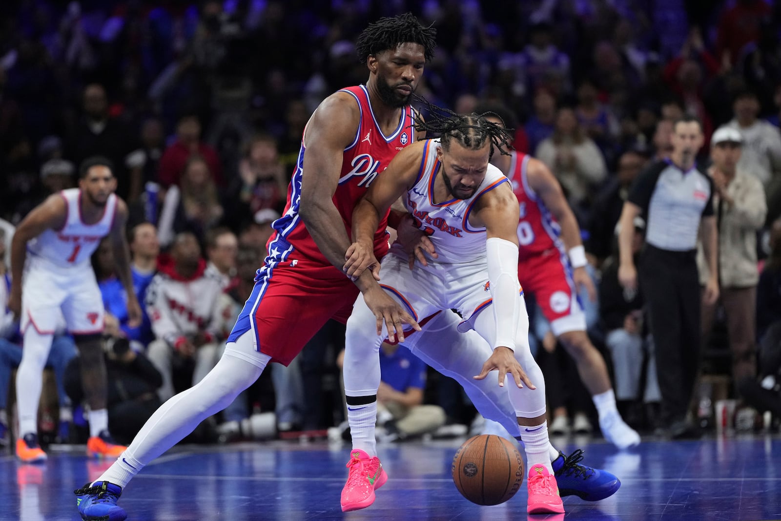 New York Knicks' Jalen Brunson, right, tries to get past Philadelphia 76ers' Joel Embiid during the second half of an Emirates NBA Cup basketball game, Tuesday, Nov. 12, 2024, in Philadelphia. (AP Photo/Matt Slocum)