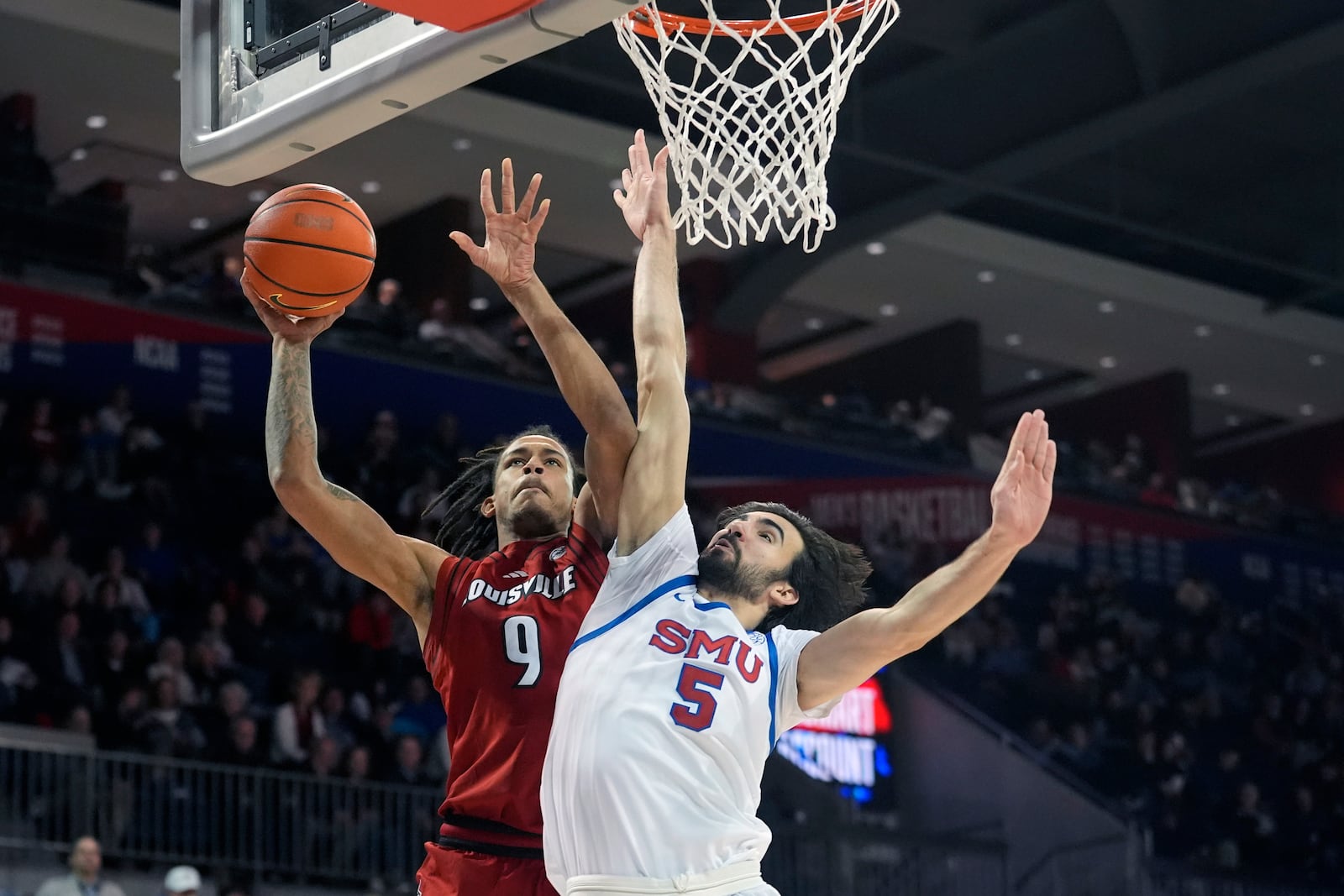 Louisville forward Khani Rooths (9) shoots against SMU forward Tibet Gorener (5) during the second half of an NCAA college basketball game, Tuesday, Jan. 21, 2025, in Dallas. (AP Photo/LM Otero)