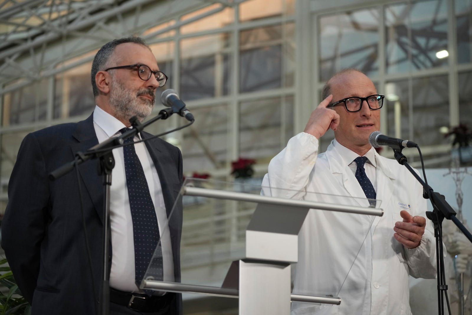 Surgeon Sergio Alfieri, right, and Pope Francis personal doctor Luigi Carboni speak to journalists, Friday, Feb. 21, 2025, in the entrance hall of Rome's Agostino Gemelli Polyclinic where Pope Francis is being treated for pneumonia. (AP Photo/Alessandra Tarantino)