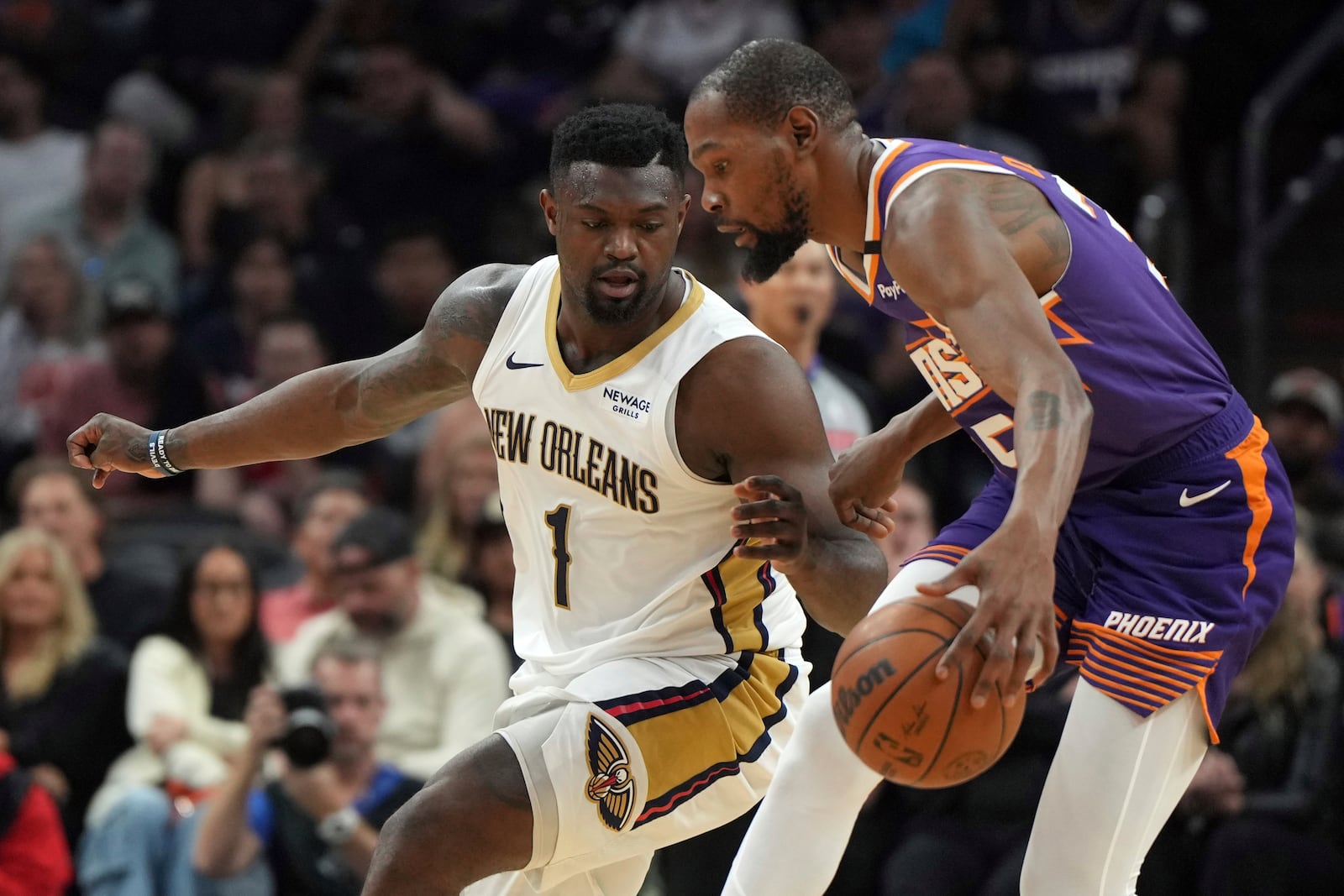 New Orleans Pelicans forward Zion Williamson (1) pressures Phoenix Suns forward Kevin Durant during the first half of an NBA basketball game, Thursday, Feb. 27, 2025, in Phoenix. (AP Photo/Rick Scuteri)