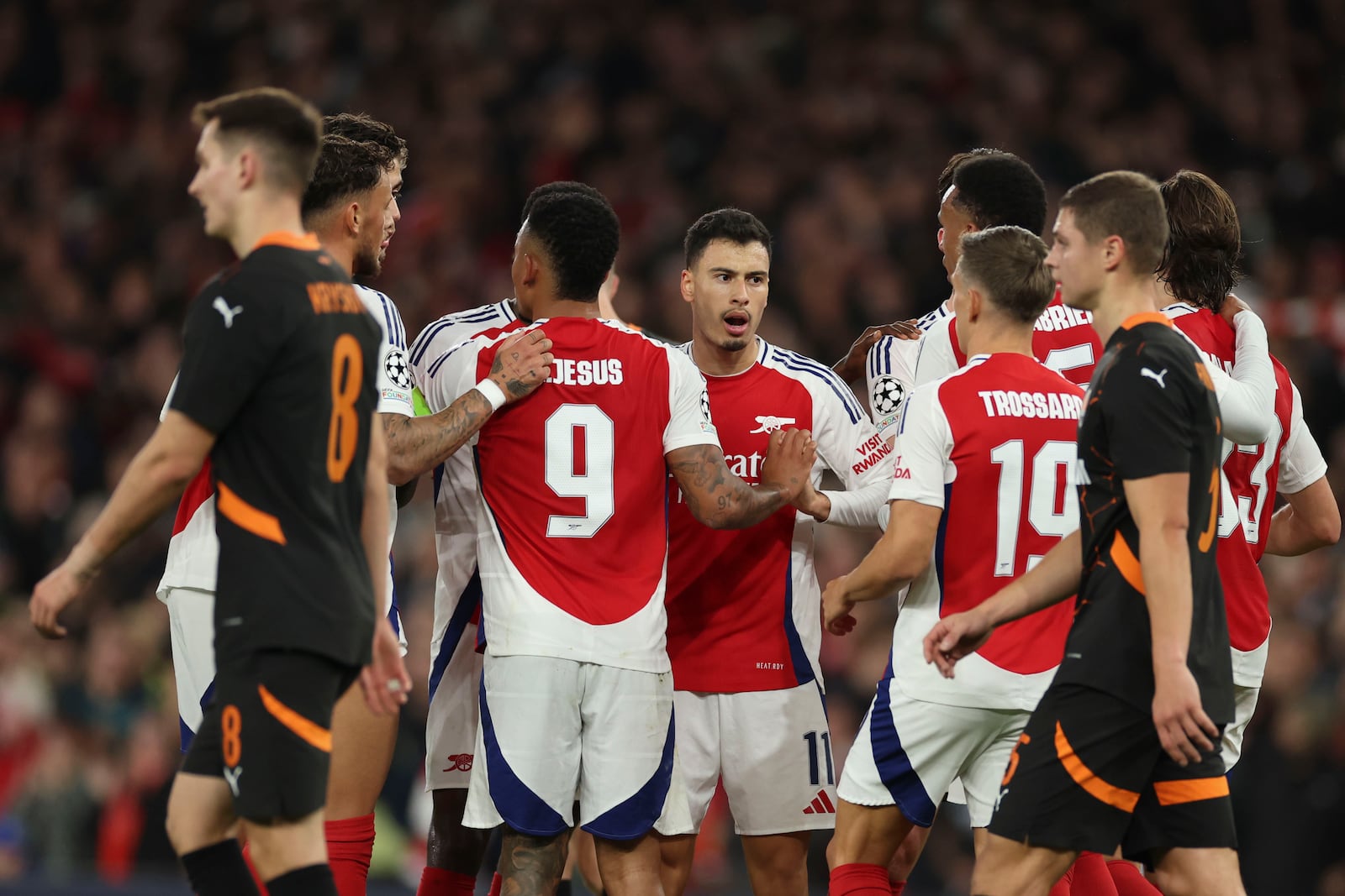 Arsenal players celebrate after Shakhtar's goalkeeper Dmytro Riznyk scoring an own goal during the Champions League opening phase soccer match between Arsenal and Shakhtar Donetsk, at the Emirates Stadium in London, Tuesday, Oct. 22, 2024. (AP Photo/Ian Walton)