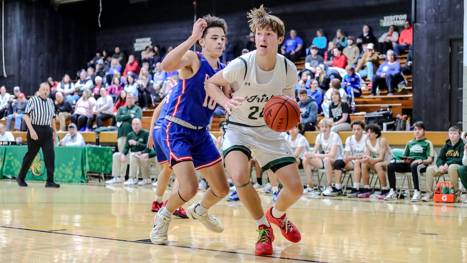 Catholic Central High School junior Keegan Guenther drives past Greeneview senior Kobie Espirit  during their game on Friday night at Jason Collier Gymnasium in Springfield. MICHAEL COOPER/CONTRIBUTED