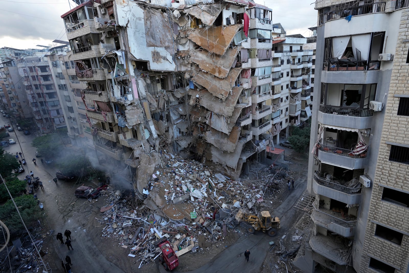 Bulldozers remove the rubble of a destroyed building that was hit Sunday night in an Israeli airstrike in Dahiyeh, in the southern suburb of Beirut, Lebanon, Monday, Nov. 25, 2024. (AP Photo/Hussein Malla)