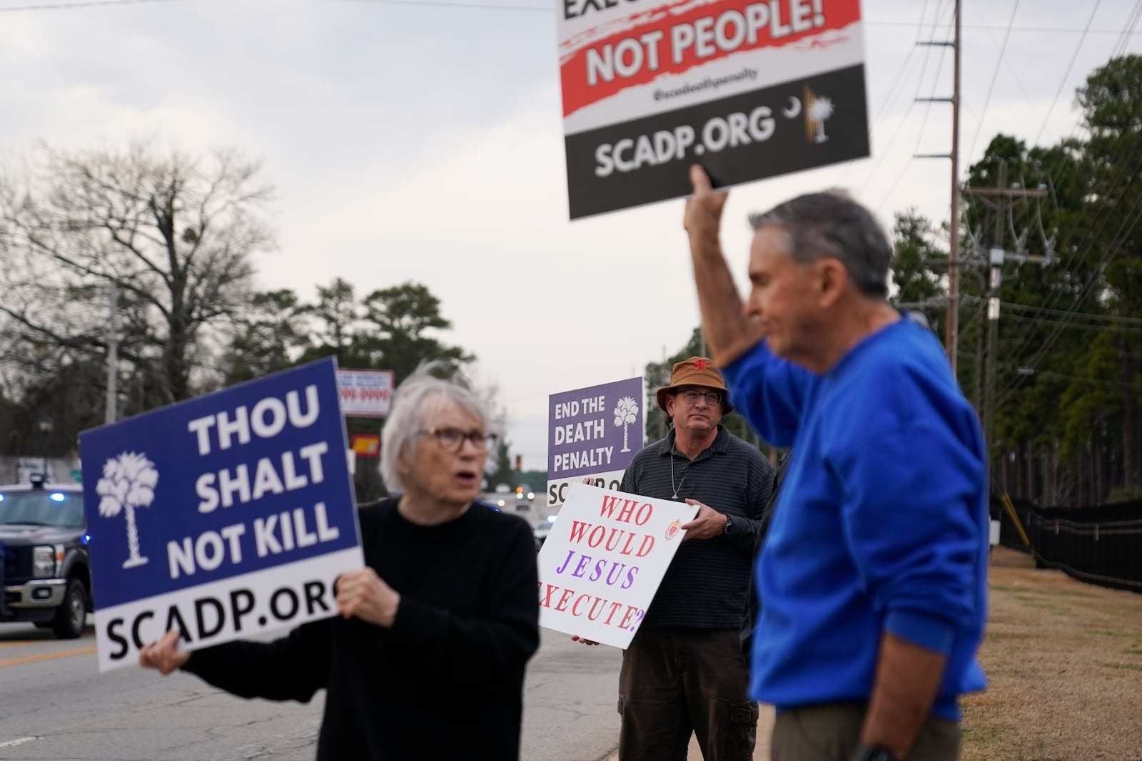 People protest prior to the scheduled execution of Marion Bowman Jr. outside of a South Carolina Department of Corrections facility, Friday, Jan. 31, 2025, in Columbia, S.C. (AP Photo/Erik Verduzco)