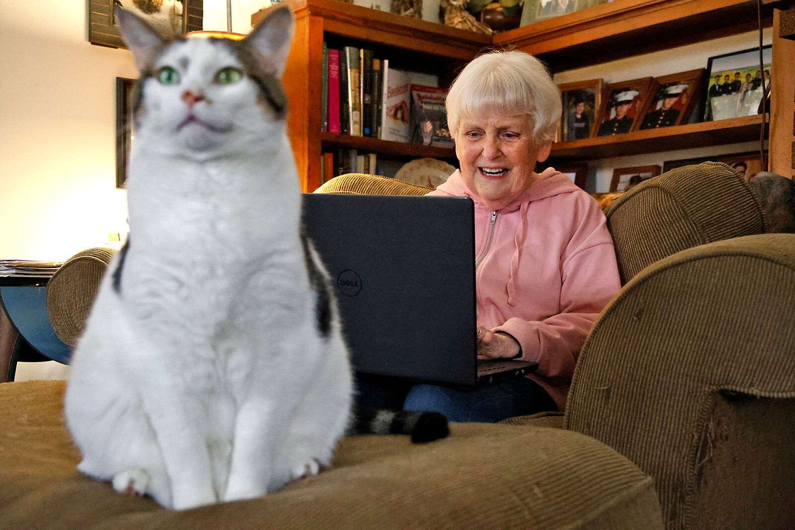 Peggy Hanna writes in her Springfield house with her companion "Izzy" Monday, Oct. 30, 2023. BILL LACKEY/STAFF