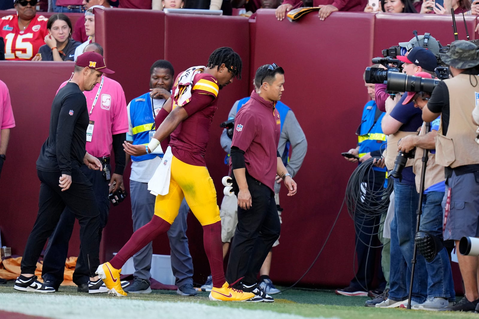 Washington Commanders quarterback Jayden Daniels walks off the field after getting injured during the first half of an NFL football game against the Carolina Panthers, Sunday, Oct. 20, 2024, in Landover, Md. (AP Photo/Stephanie Scarbrough)