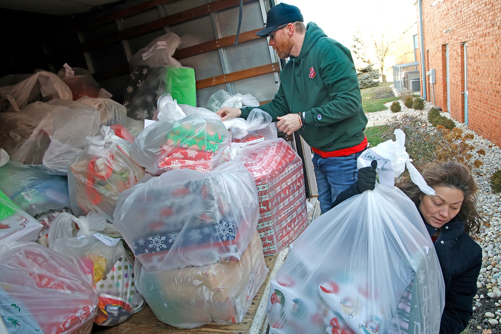 The Salvation Army staff and volunteers loaded a box truck with Christmas presents for individuals taking part in their Senior Angel Tree program Wednesday, Dec. 20, 2023. Senior Angel Tree provides gifts for around 200 seniors living in three nursing homes in the Springfield area who wouldn’t have any presents for the holiday. According to Ryan Ray, director of development at the Springfield Salvation Army, pictured at top, “Most of these seniors have next to nothing in their lives. Most don’t receive a single call, text or piece of mail all year.” Ray said, “It sends a message to them that they matter and that they are profoundly loved.”  BILL LACKEY/STAFF