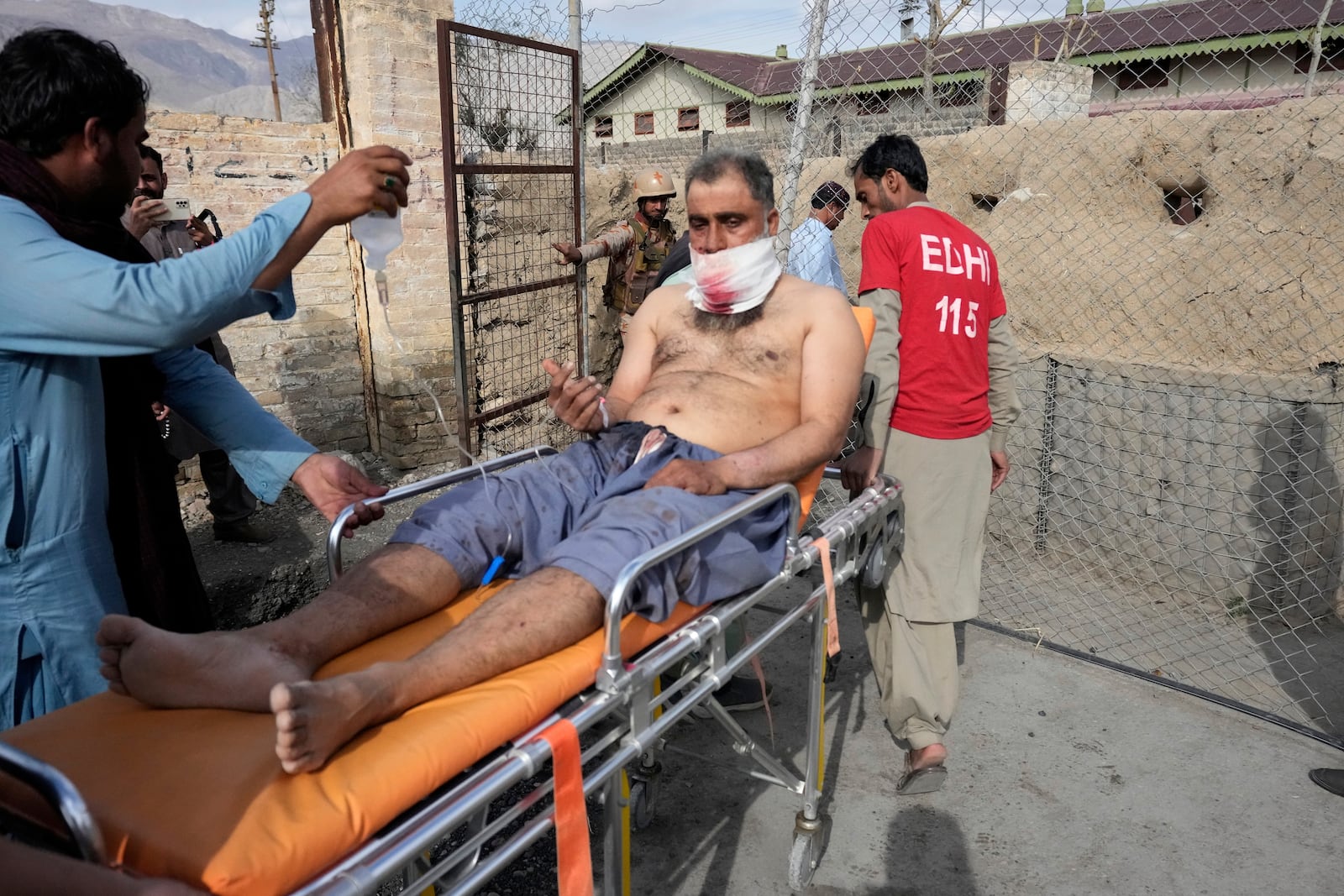 An injured passenger rescued by security forces from a passenger train attacked by insurgents arrive at a railway station in Much near Quetta, Pakistan's southwestern Balochistan province, Wednesday, March 12, 2025. (AP Photo/Anjum Naveed)