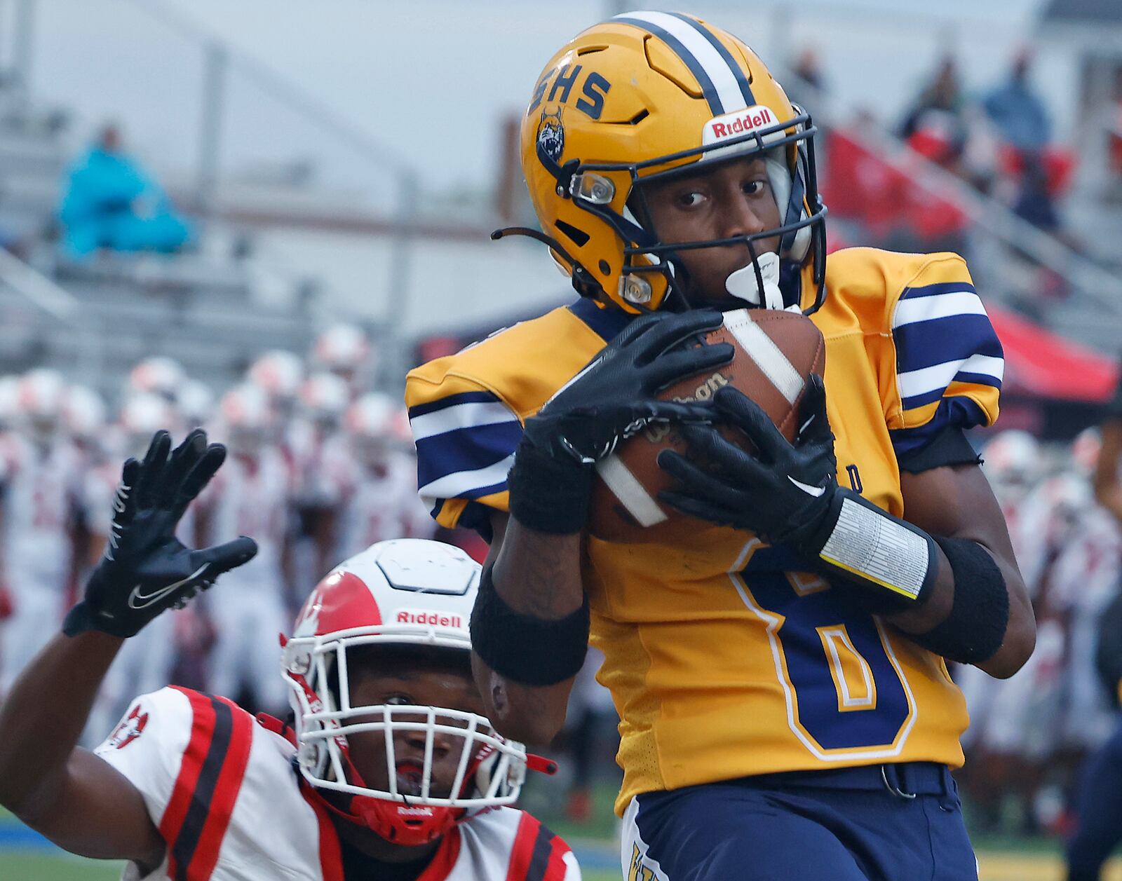 Springfield's Sherrod Lay catches a touchdown pass in the first quarter of their game against Trotwood. BILL LACKEY/STAFF