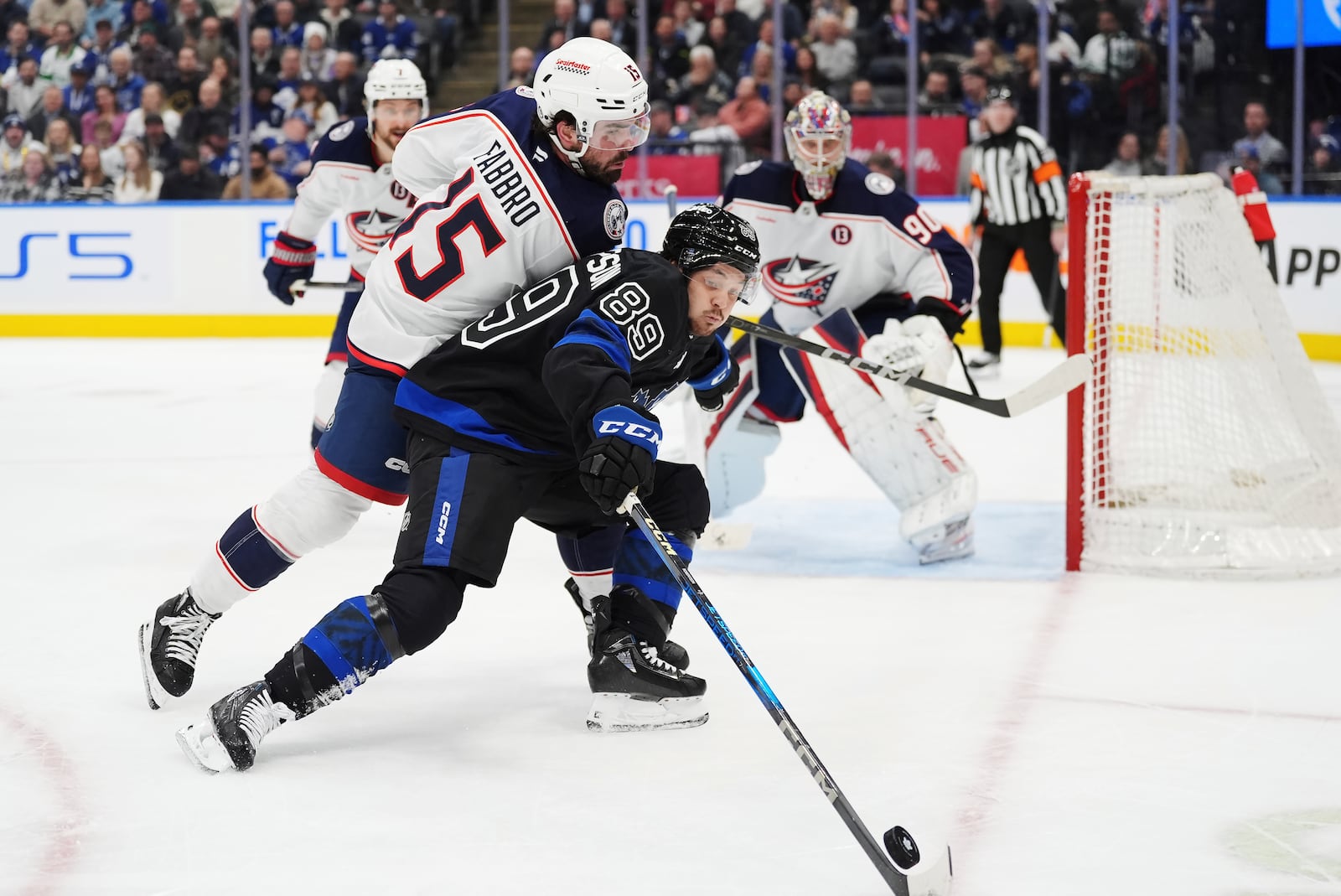 Toronto Maple Leafs' Nicholas Robertson (89) protects the puck from Columbus Blue Jackets' Dante Fabbro during the second period of an NHL hockey game in Toronto on Wednesday, Jan. 22, 2025. (Frank Gunn/The Canadian Press via AP)