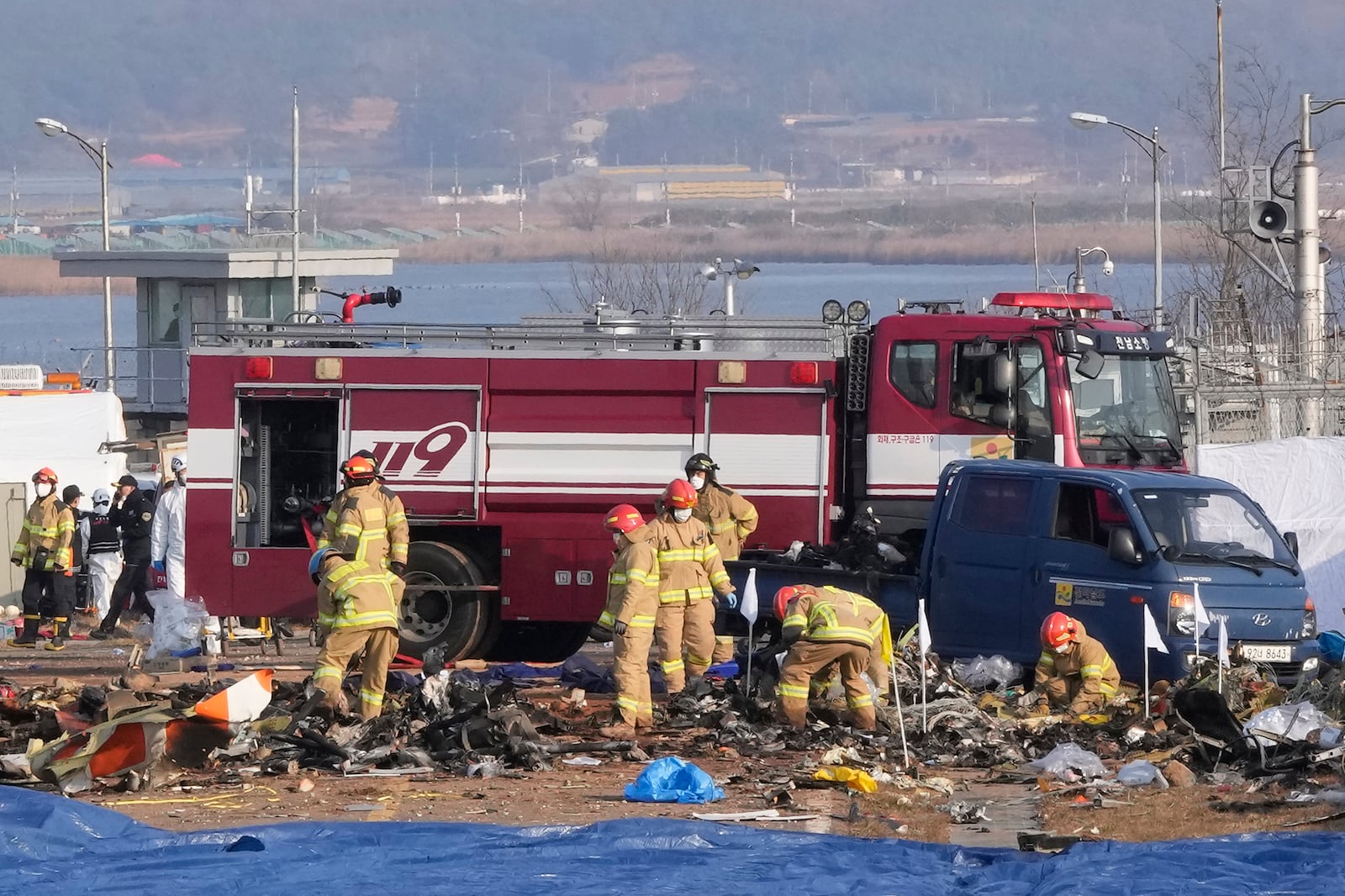 Rescue team members work at Muan International Airport in Muan, South Korea, Sunday, Dec. 29, 2024. (AP Photo/Ahn Young-joon)