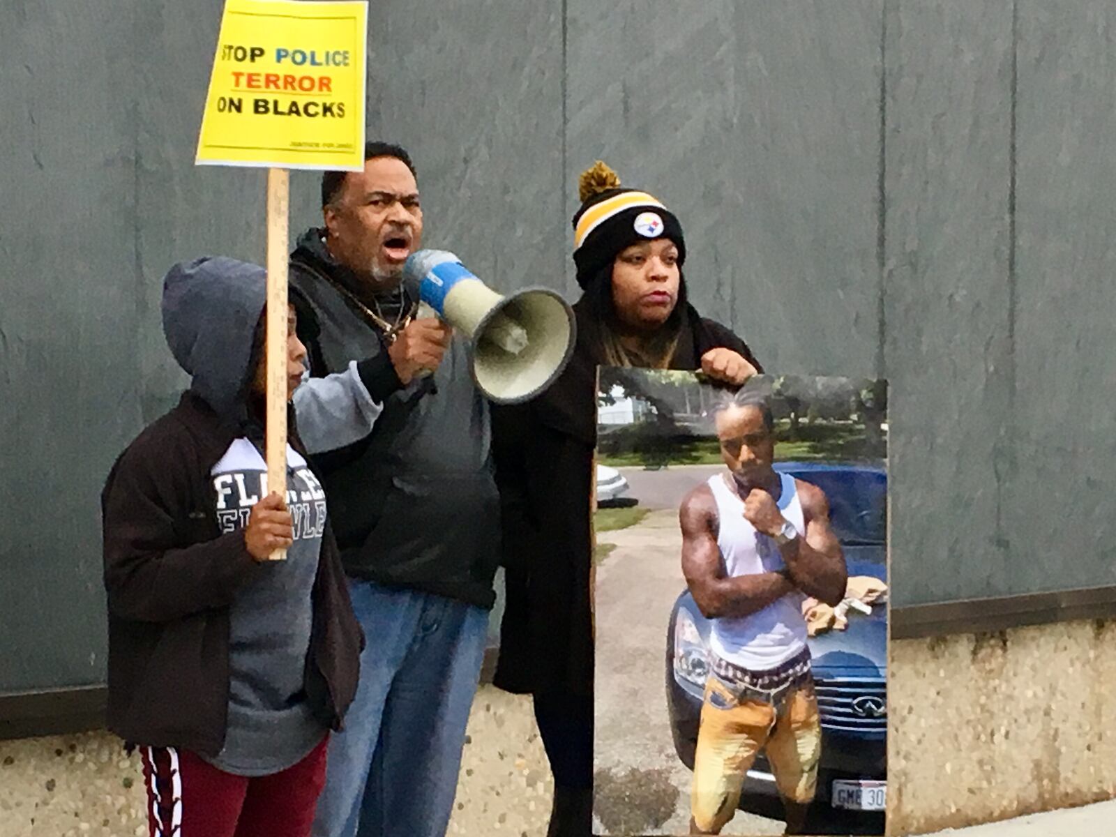 Dashelle Starks (the mother of Jamarco McShann’s son), Rev. Jerome McCorry and Sabrina Jordan (mother of McShann) address the crowd Saturday at a rally at the Moraine police department to protest the death of McShann by Moraine police officers. MARK GOKAVI / STAFF