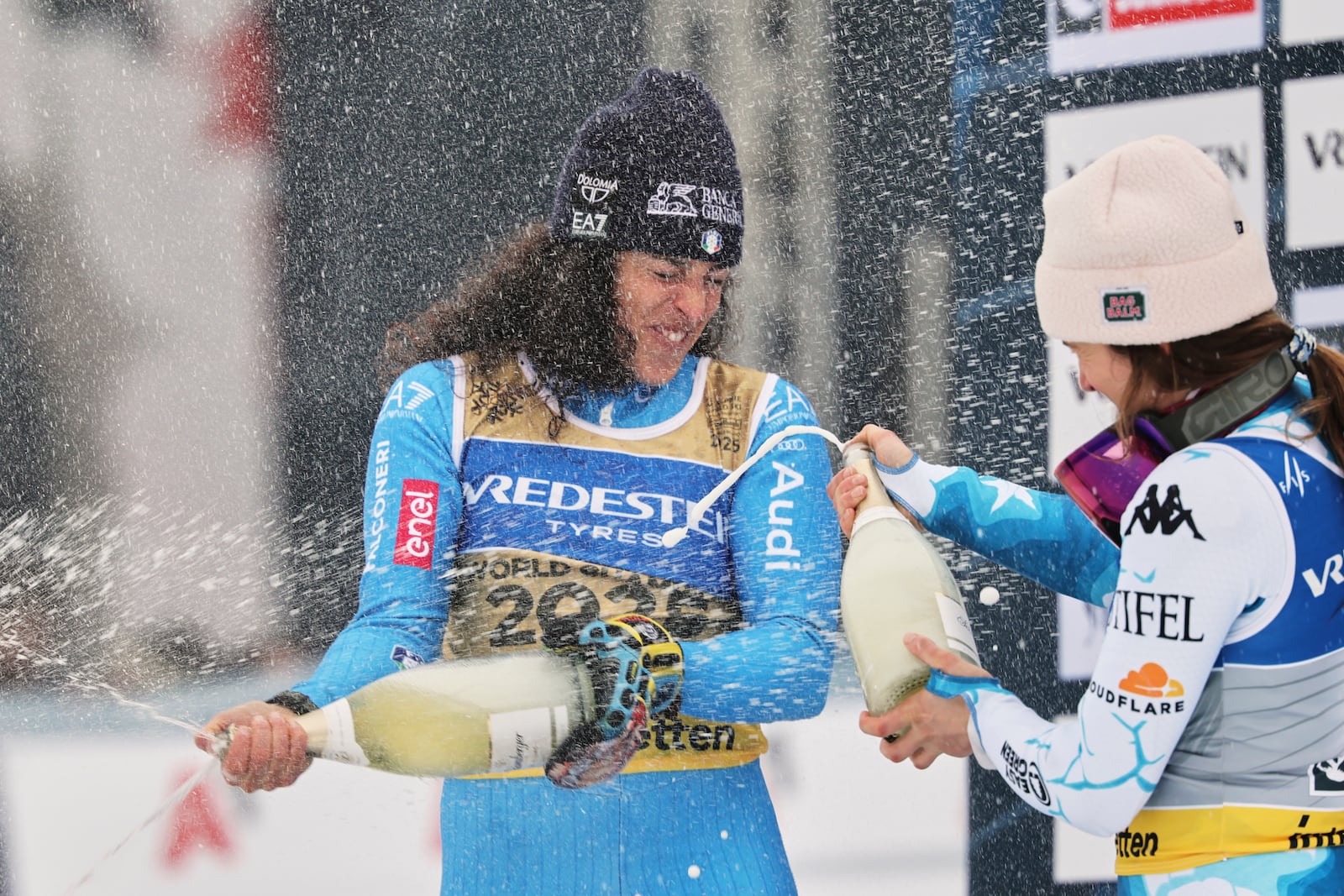 Italy's Federica Brignone, center, celebrates winning g a gold medal in a women's giant slalom with bronze medalist United States' Paula Moltzan, at the Alpine Ski World Championships, in Saalbach-Hinterglemm, Austria, Thursday, Feb. 13, 2025. (AP Photo/Marco Trovati)