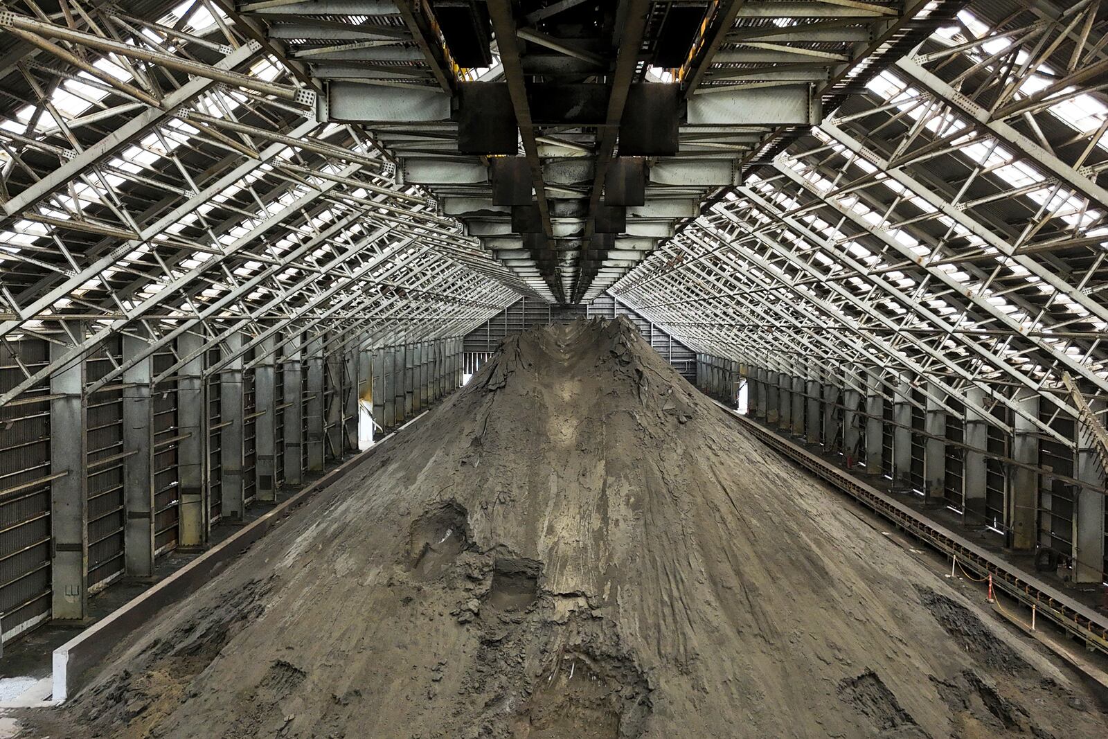 Copper ore piles up at the Cobre Panama copper mine, owned by Canada's First Quantum Minerals, during a media tour of the mine that was closed after Panama's Supreme Court ruled that the government concession was unconstitutional, in Donoso, Panama, Friday, March 21, 2025. (AP Photo/Matias Delacroix)