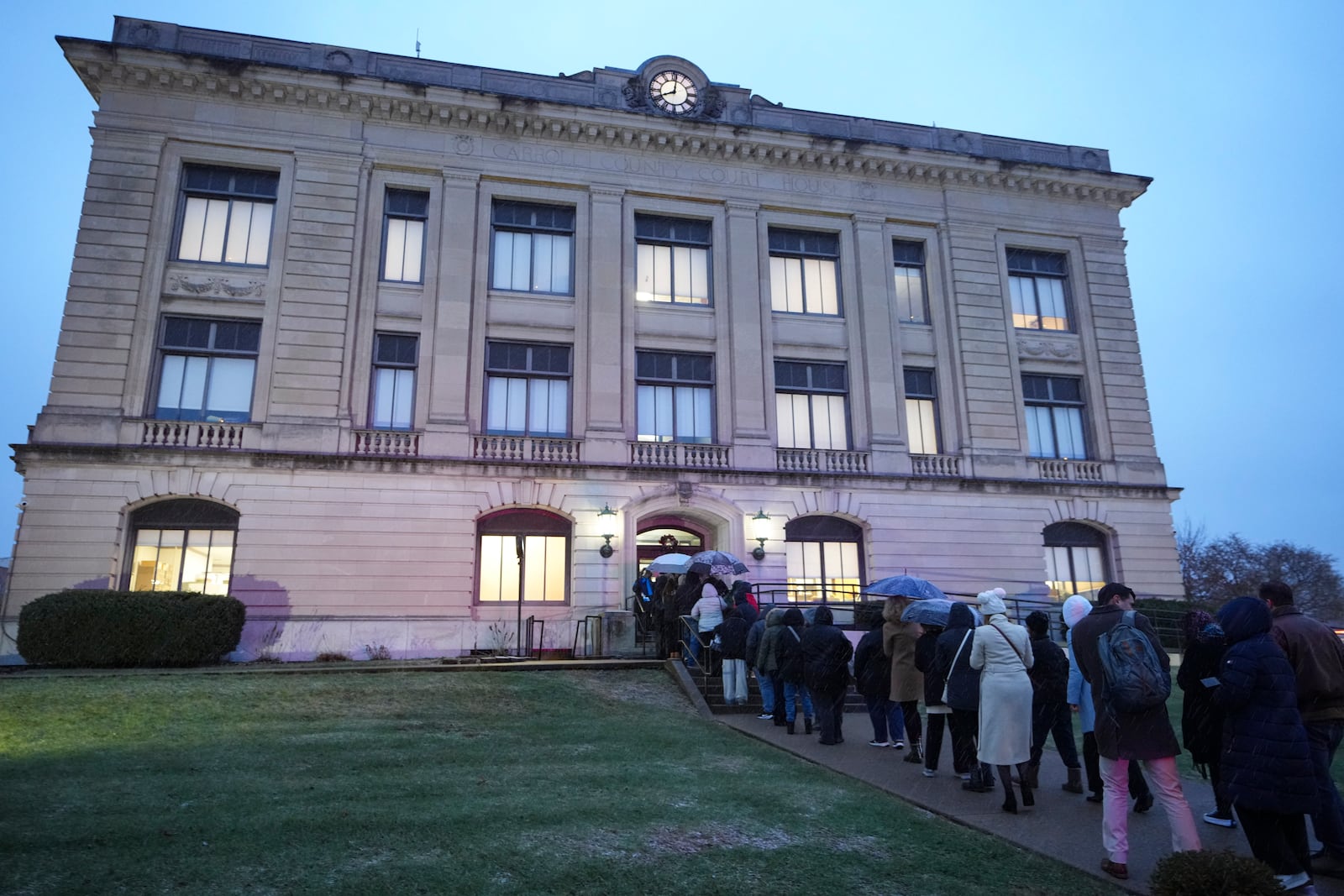 Spectators line up to enter the Carroll County Courthouse for the sentencing of Richard Allen, convicted in the 2017 killings of two teenage girls , in Delphi, Ind., Friday, Dec. 20, 2024. (AP Photo/Michael Conroy)