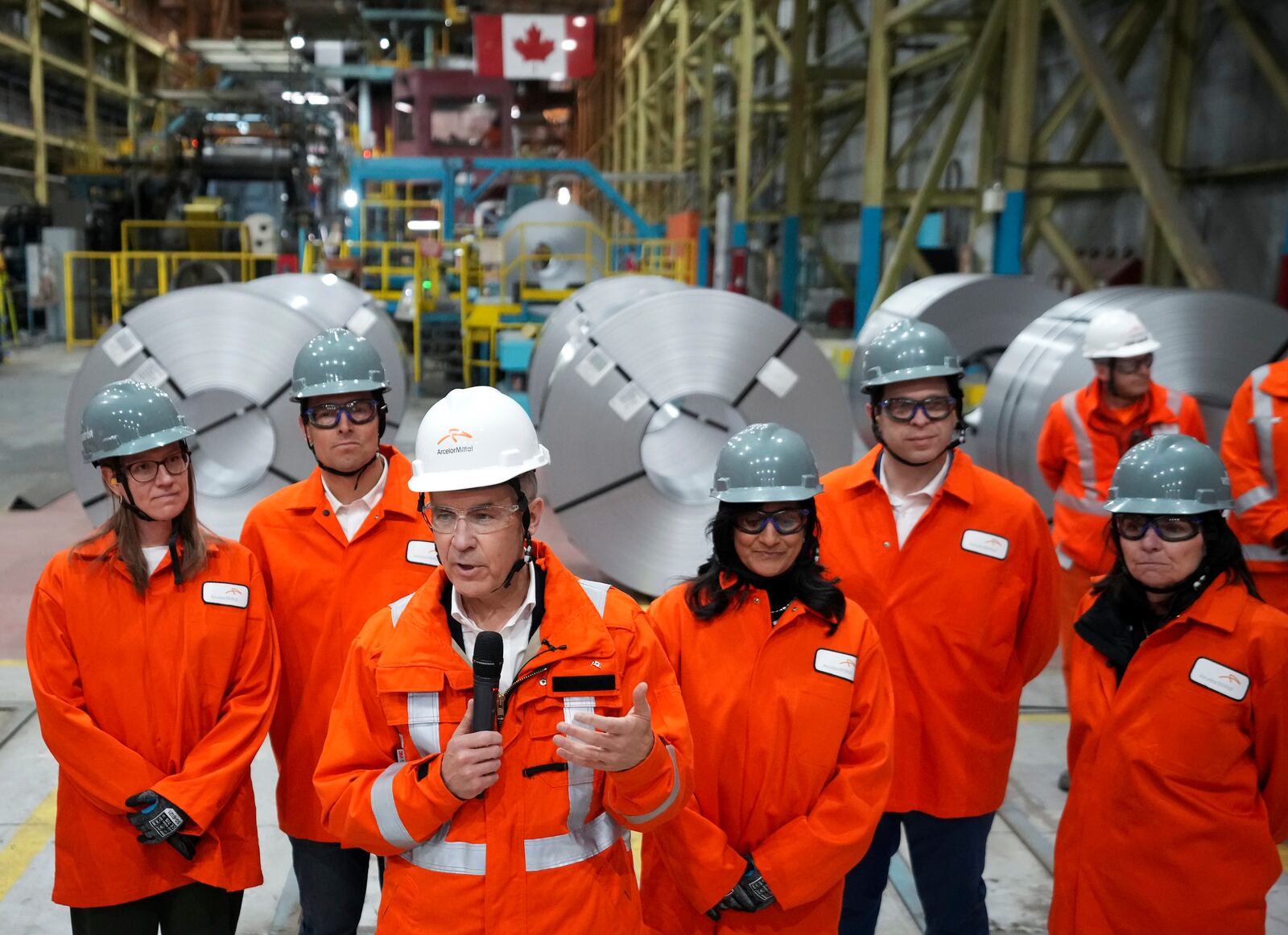 Canadian Prime Minister designate Mark Carney, third left, speaks to steel workers after touring the ArcelorMittal Dofasco steel plant in Hamilton, Ont., on Wednesday, March 12, 2025. (Nathan Denette /The Canadian Press via AP)