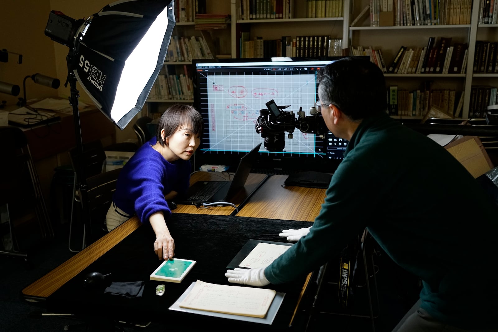 Ai Saotome, left, a video archivist, works with her husband, Shinji Teruya, to digitize old manuscripts of her father, Honorary Director Katsumoto Saotome, at the Center of the Tokyo Raids and War Damage on Feb. 4, 2025, in Tokyo. (AP Photo/Eugene Hoshiko)