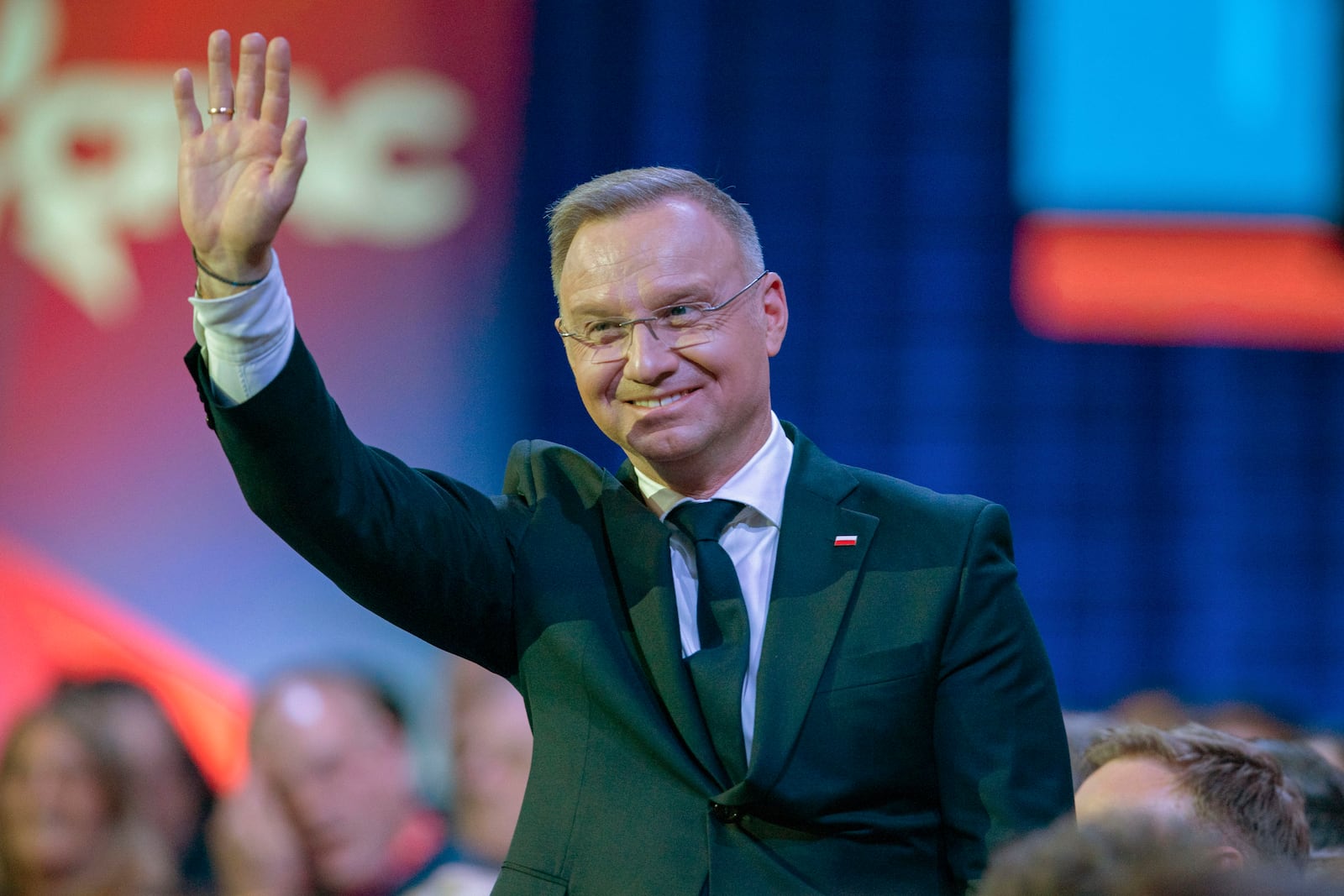 Polish President Andrzej Duda waves to President Donald Trump at the Conservative Political Action Conference, CPAC, at the Gaylord National Resort & Convention Center, Saturday, Feb. 22, 2025, in Oxon Hill, Md. (AP Photo/Jose Luis Magana)