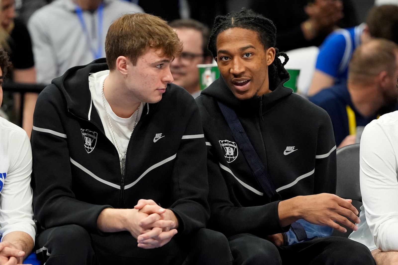 Duke forward Cooper Flagg, left, and forward Maliq Brown watch from the bench during the second half of an NCAA college basketball game against North Carolina in the semifinals of the Atlantic Coast Conference tournament, Friday, March 14, 2025, in Charlotte, N.C. Flagg and Brown were injured yesterday. (AP Photo/Chris Carlson)