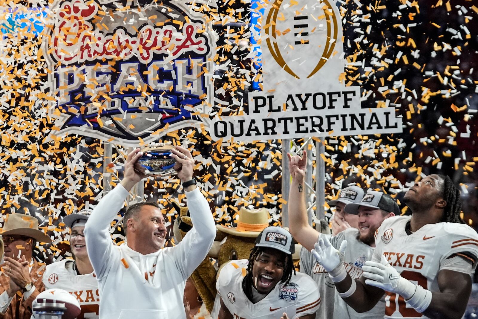 Texas players celebrate victory after a quarterfinals College Football Playoff game against Arizona State, Wednesday, Jan. 1, 2025, in Atlanta. Texas won 39-31 in two overtime periods. (AP Photo/John Bazemore)