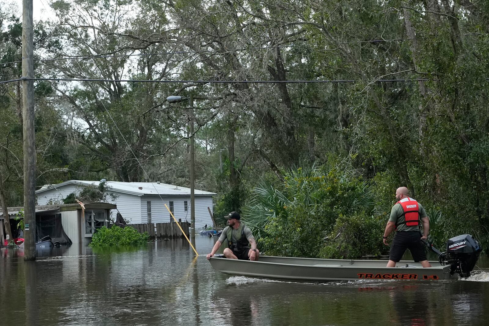 Members of the Hillsborough County Sheriff's office drive a boat through floodwaters from Hurricane Milton near the Alafia River Friday, Oct. 11, 2024, in Lithia, Fla. (AP Photo/Chris O'Meara)