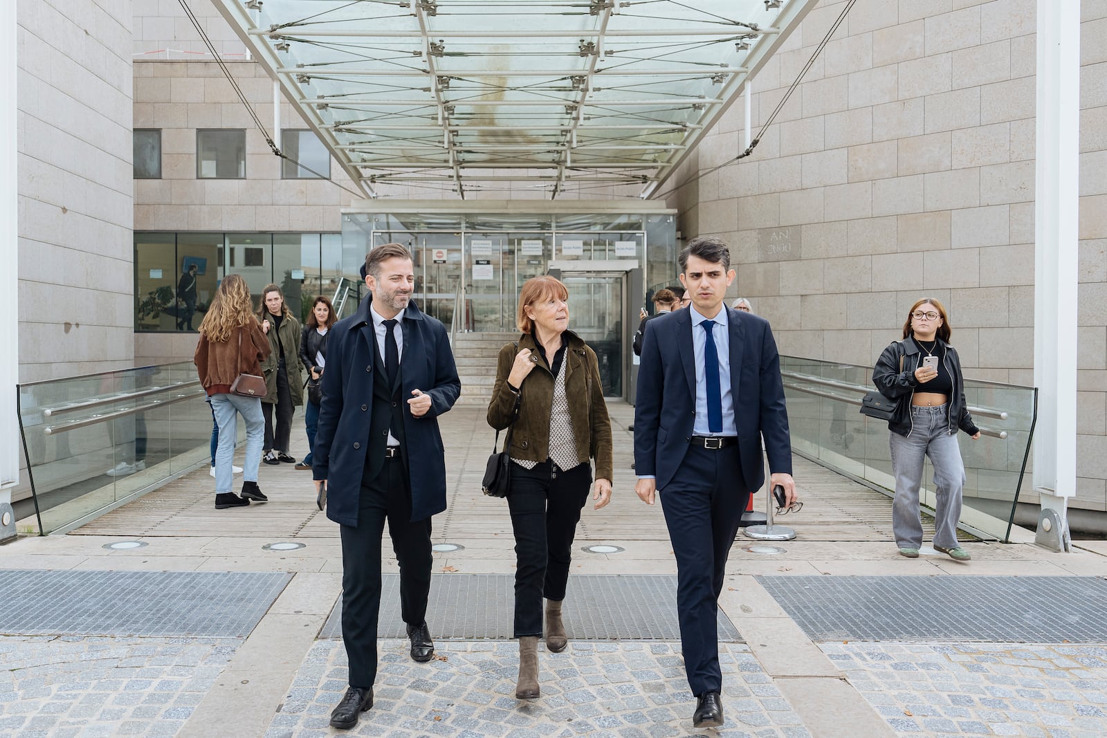 FILE - Gisele Pelicot, center, who was allegedly drugged by her now ex-husband so that she could be raped while unconscious by other men, leaves the court house, in Avignon, southern France, on Oct. 16, 2024. (AP Photo/Lewis Joly, File)