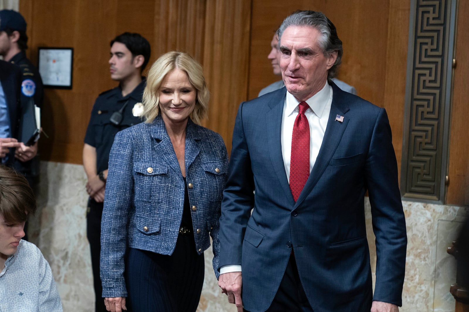 Former Gov. Doug Burgum, President-elect Donald Trump's choice to lead the the Interior Department as Secretary of the Interior, right, arrives with his wife Kathryn Burgum to testify before the Senate Energy and Natural Resources Committee on Capitol Hill in Washington, Thursday, Jan. 16, 2025. (AP Photo/Jose Luis Magana)