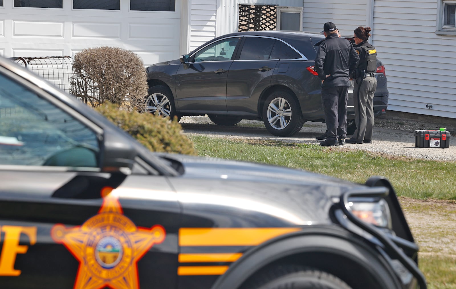 The Clark County Sheriff's Office investigates a shooting at a home in the 7000 block of South Charleston-Clifton Road Monday, March 25, 2024. Deputies arrived at the home to find a woman shot in the driveway and an 81-year-old man with injuries. The woman was flown by MedFlight to Kettering Health Main Campus, where she later died, while the man was transported to the hospital by medic. BILL LACKEY/STAFF